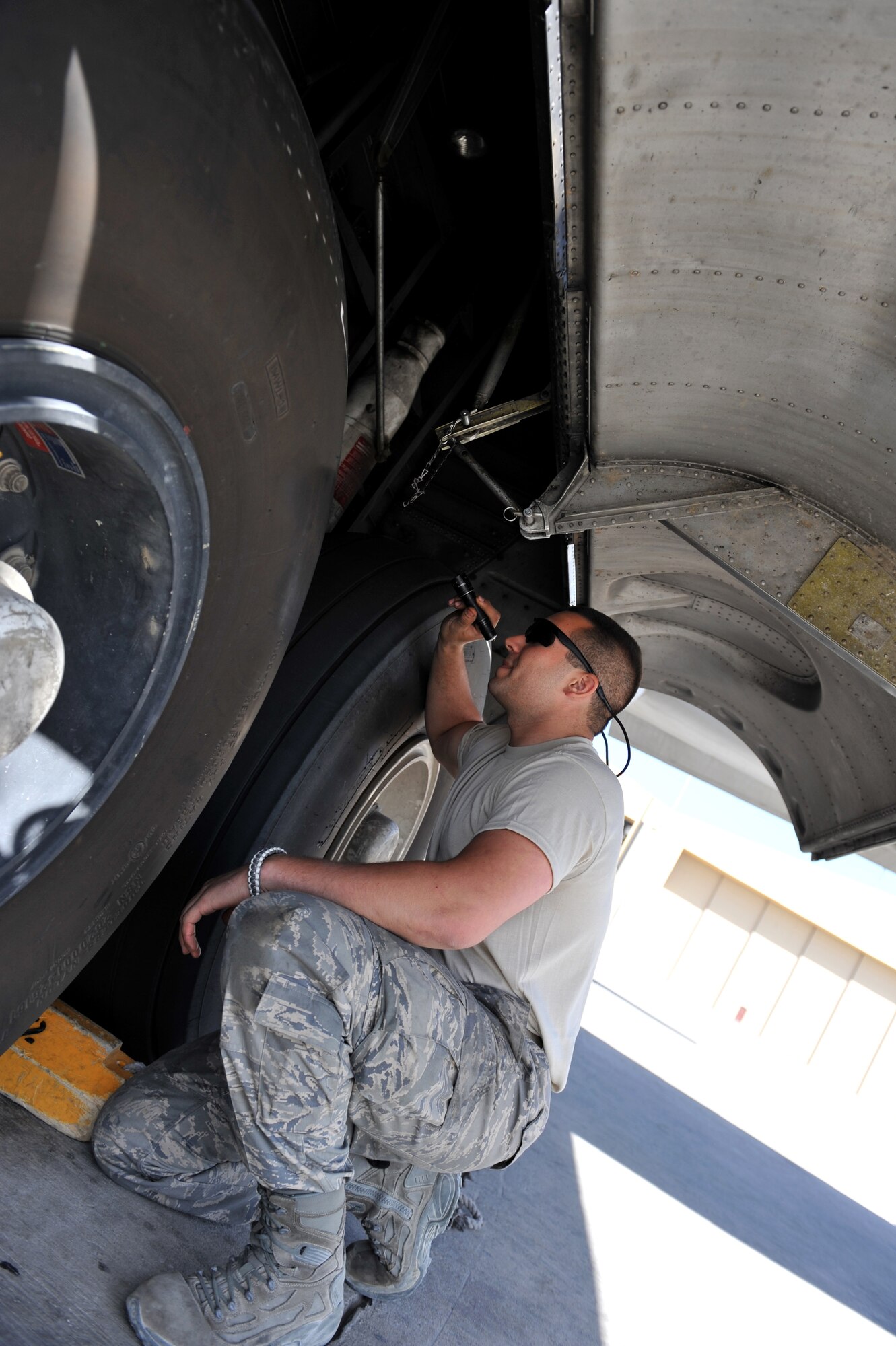 Senior Airman Donald Pruitt, 455th Expeditionary Aircraft Maintenance Squadron crewchief, does a routine tire and brake inspection on a C-130 Hercules at Bagram Airfield, Afghanistan, June 2, 2011. Airman Pruitt is deployed from the 136th Maintenance Squadron, Texas Air National Guard, Texas and is a native of Richardson, Texas. (U.S. Air Force photo by Senior Airman Sheila deVera)