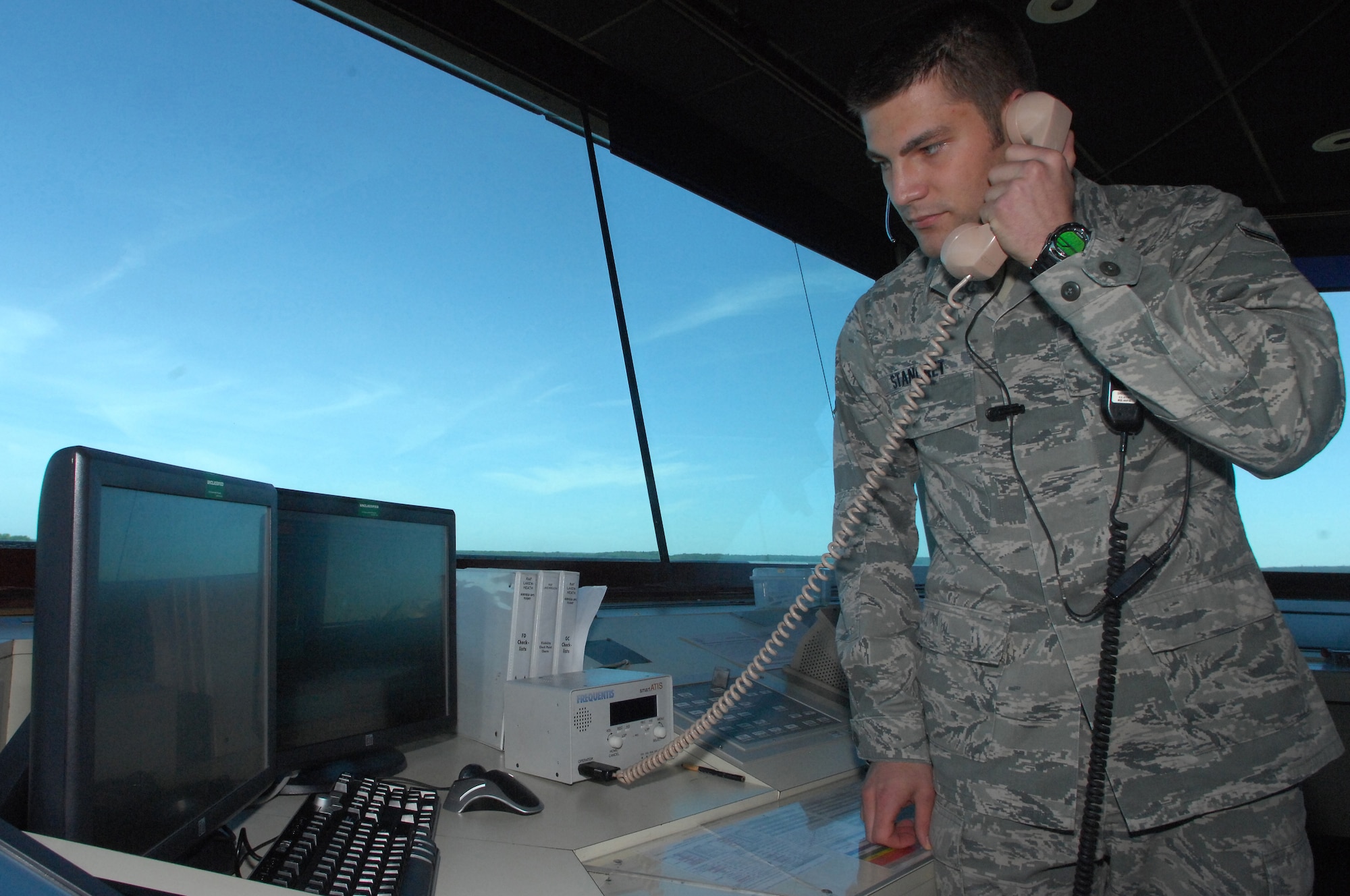 ROYAL AIR FORCE LAKENHEATH, England -- Airman 1st Class Keagan Stangret, 48th Operations Support Squadron Air Traffic Control apprentice, informs inbound aircraft of weather and wind conditions during take-off and landings at the Air Traffic Control tower June 1, 2011. Airman Stangret was nominated for the Liberty Spotlight because he displayed the core value "Excellence in All We Do". (U.S. Air Force photo/Senior Airman Eboni Reams)