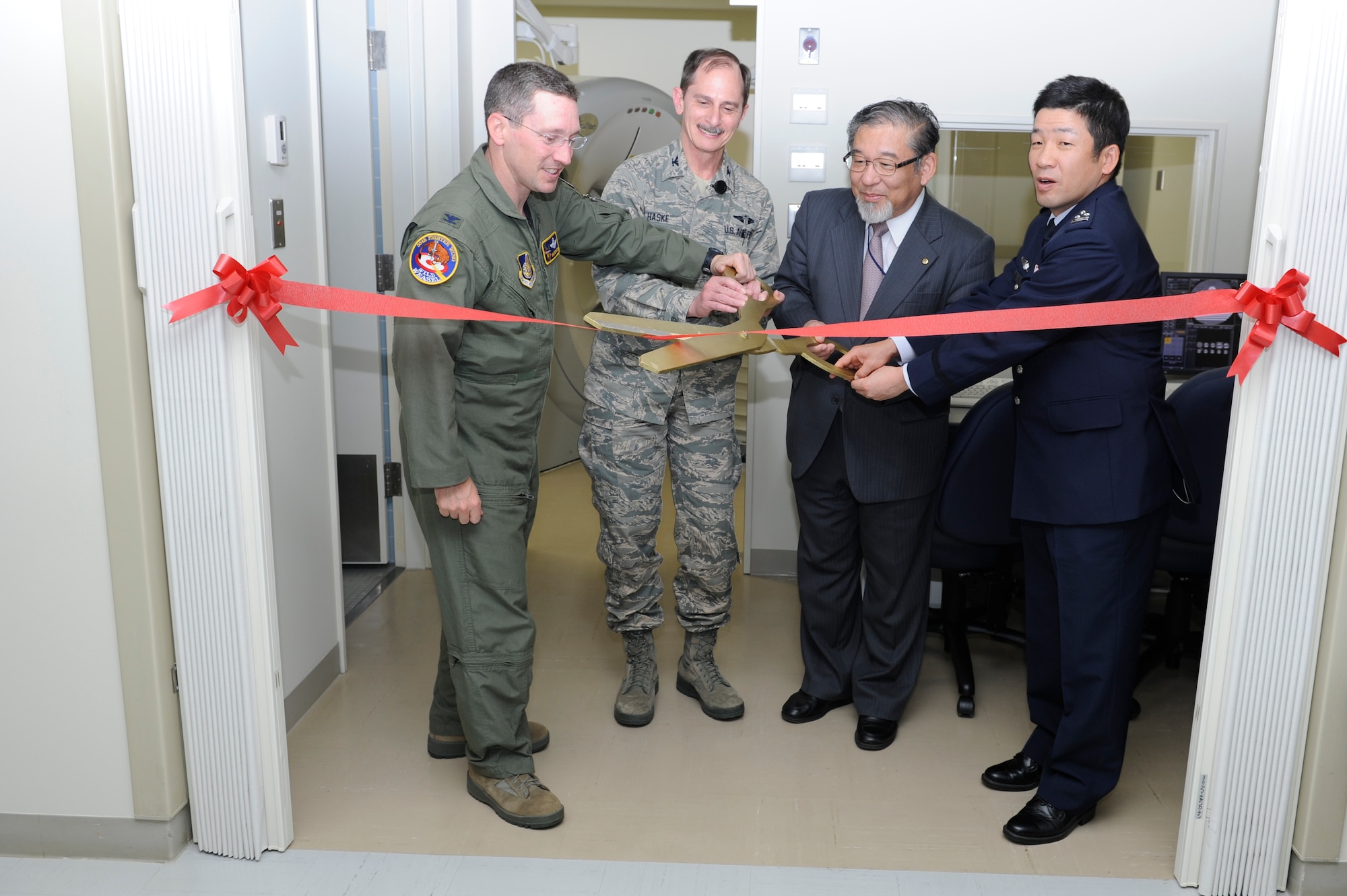 MISAWA AIR BASE, Japan -- Left to right: Col. Michael Rothstein, 35th Fighter Wing commander; Col. Terry Haske, 35th Medical Group commander; Dr. Yuh Sakata, Misawa City Hospital chief executive Officer; and Col. Shinya Bekku, Japan Air Self-Defense Force Misawa Hospital commander, cut the ribbon for the new CT scanner at the 35th MDG Diagnostic Imaging Department June 1. The 35th MDG Diagnostic Imaging Department provides imaging support 24/7 for the Misawa military treatment 
facility. (U.S. Air Force photo/Staff Sgt. Marie Brown/Released)