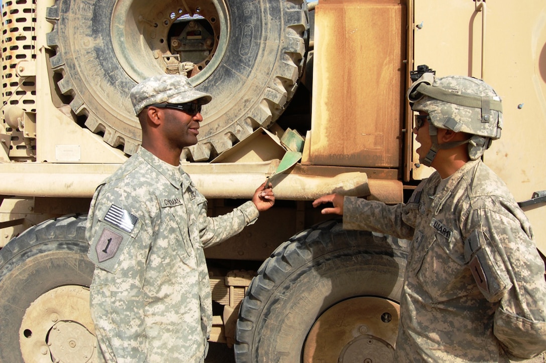 Army Sgt. Marcus Chatman, left, inspects a palletized load system at ...