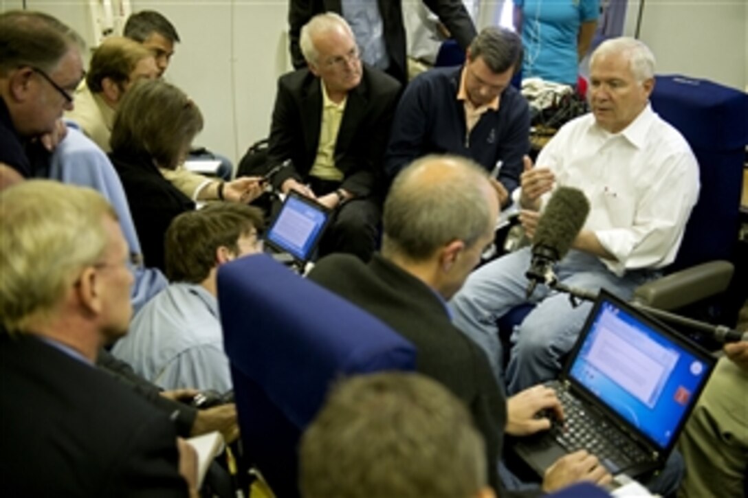 Secretary of Defense Robert M. Gates speaks with members of the press onboard an E-4B aircraft enroute to Singapore on June 1, 2011.  