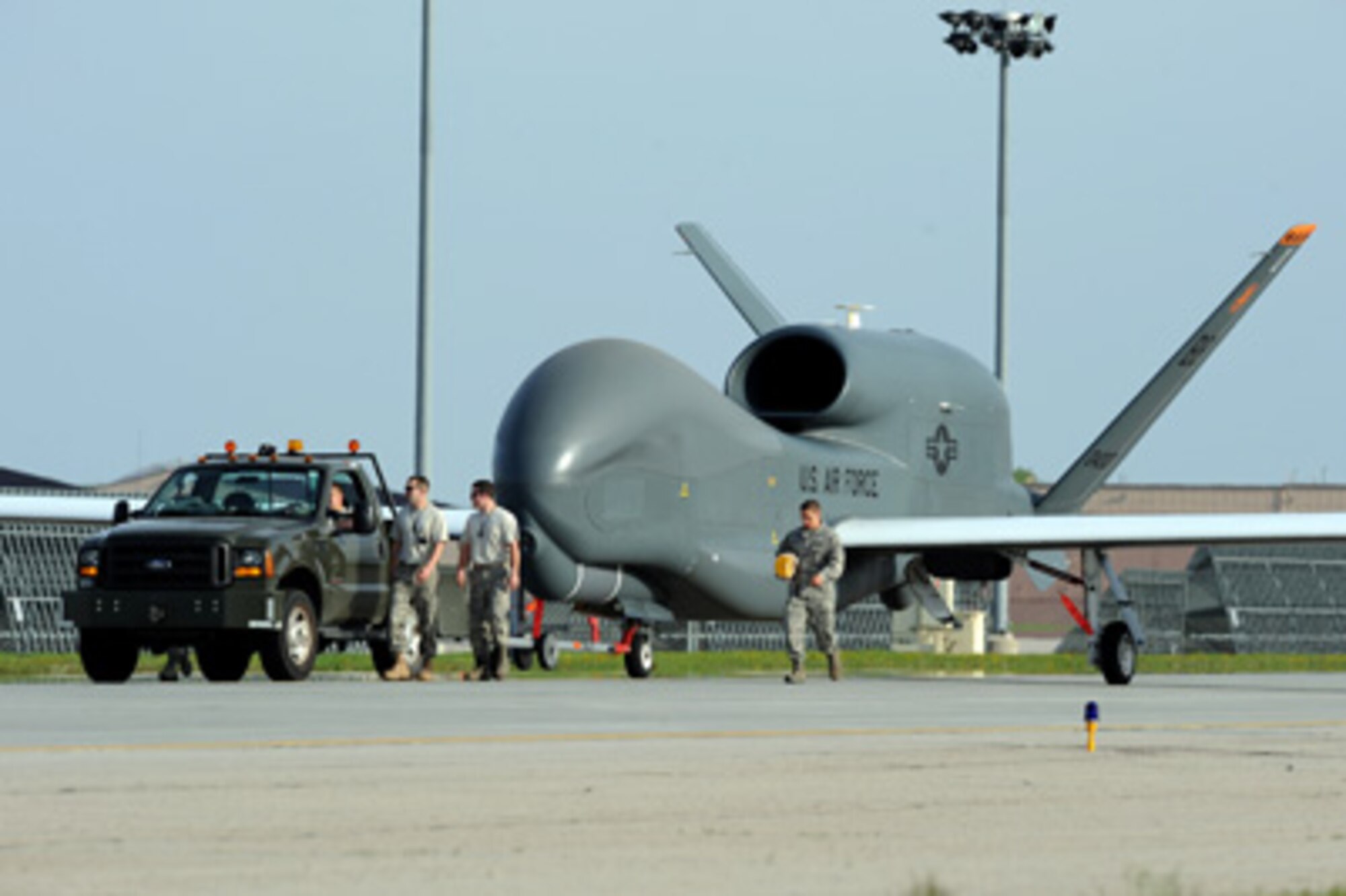 Airmen from Grand Forks Air Force Base, N.D., welcome the first RQ-4 Global Hawk to the base May 26, 2011. The arrival marked the beginning of a new era of remotely piloted aircraft at the base. (U.S. Air Force photo/Tech. Sgt. Johnny Saldivar)