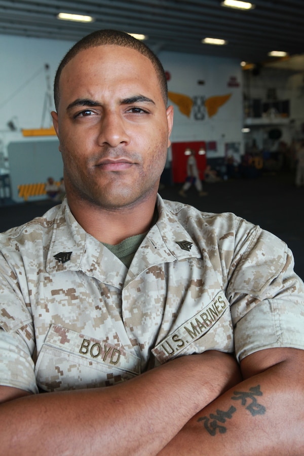 Sgt. Stephen Boyd an assault amphibious vehicle repairer/technician with 2nd Amphi currently attached to the 24th Marine Expeditionary Unit poses f the USS Iwo Jima (LHD -7) and USS New York (LPD-21) to take part and also honored those who have served by participating in various events during the Memorial Day weekend.