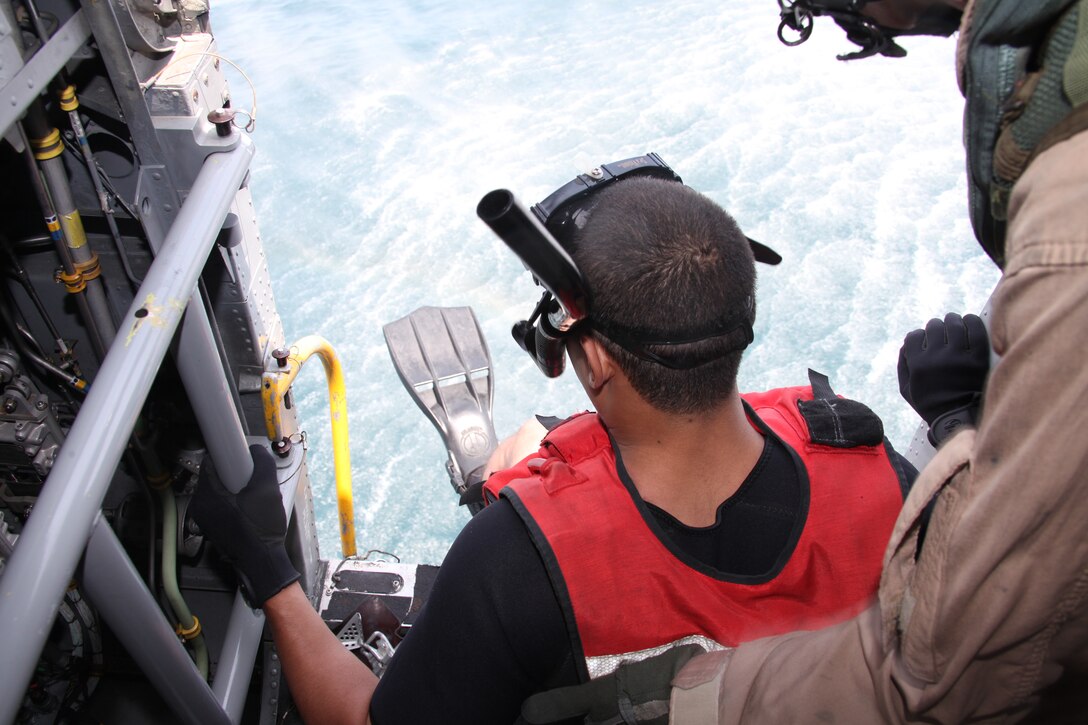 Seaman Michael S. Harris prepares to jump into the ocean off the coast of Fort Macon during the swimmer deployment portion of Marine Transport Squadron 1 search and rescue certification testing June 3. Harris is training to become a rescue swimmer with VMR-1.