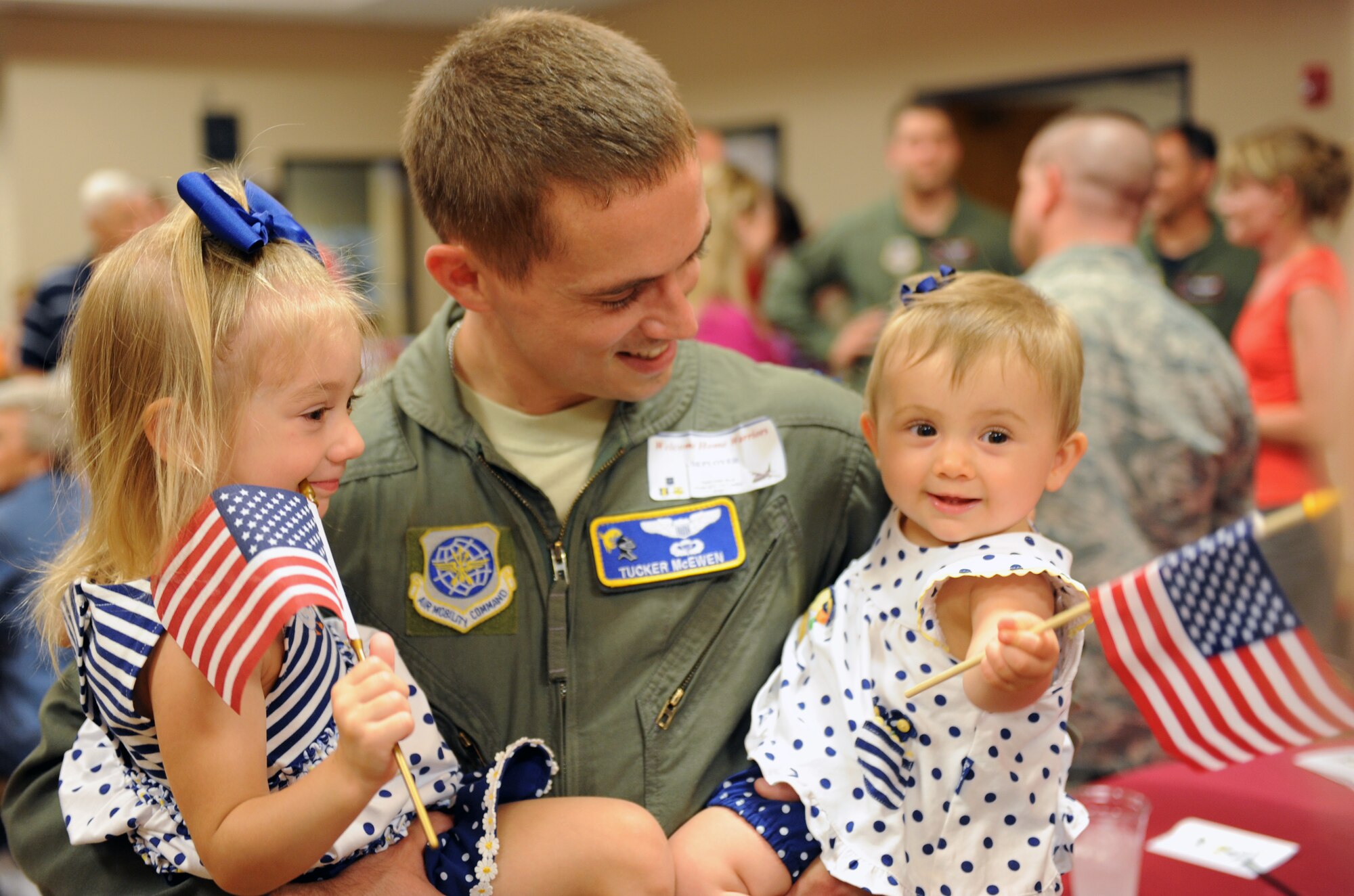 Capt. Eric McEwen, a 19th Operations Support Squadron flight safety member, embraces his children during the Welcome Home Warriors event June 3, 2011, at Little Rock Air Force Base, Ark. The event is designed to recognize individual deployers who returned home through commercial airports. The event also included a special “Welcome Home” presentation for Vietnam War veterans. (U.S. Air Force photo/Airman 1st Class Rusty Frank)