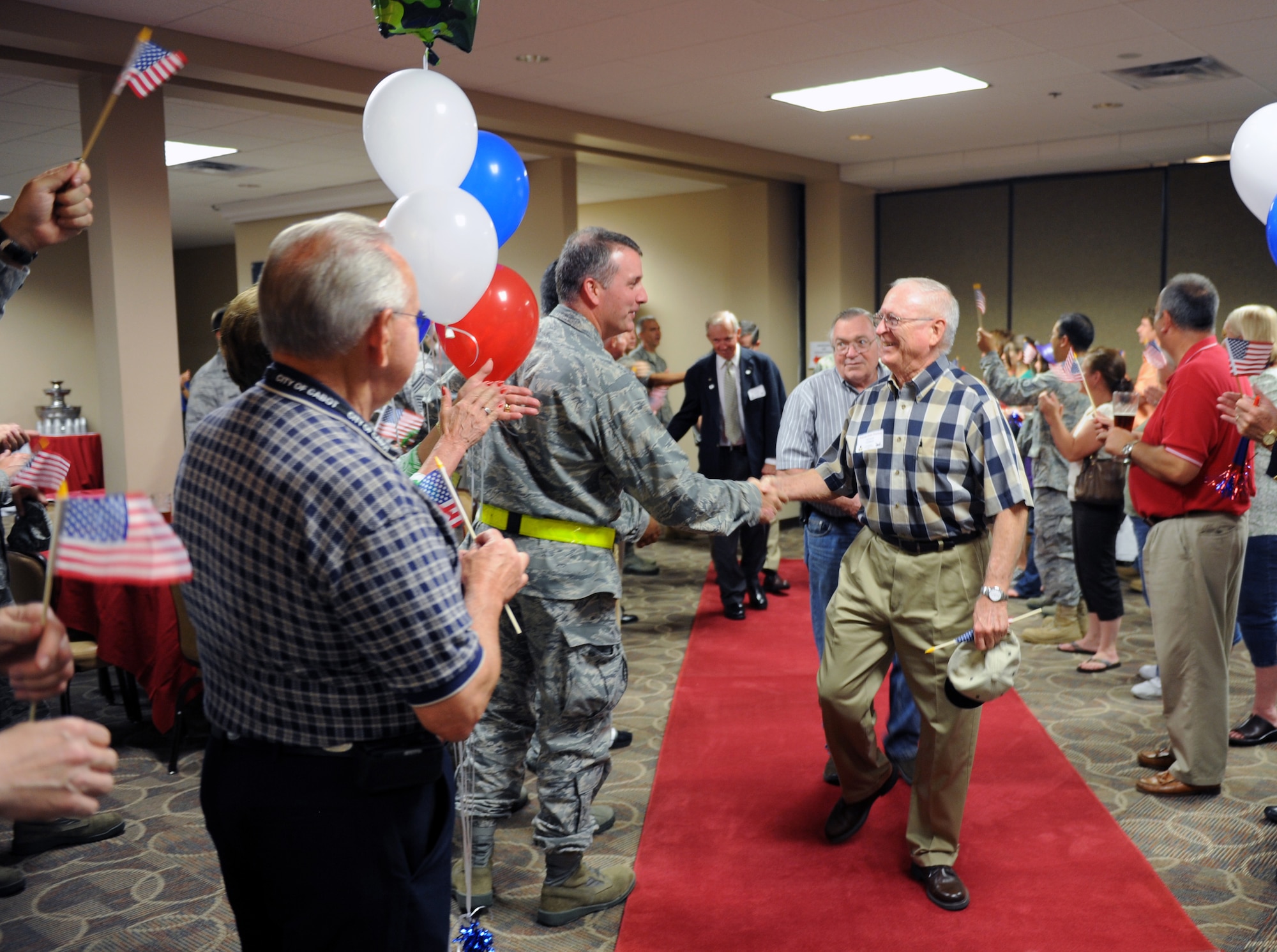 Vietnam veterans are greeted by Team Little Rock friends and family members during the Welcome Home Warriors event June 3, 2011, at Little Rock Air Force Base, Ark. The event is designed to recognize individual deployers who returned home through commercial airports. The event also included a special “Welcome Home” presentation for Vietnam War veterans. (U.S. Air Force photo/Airman 1st Class Rusty Frank)