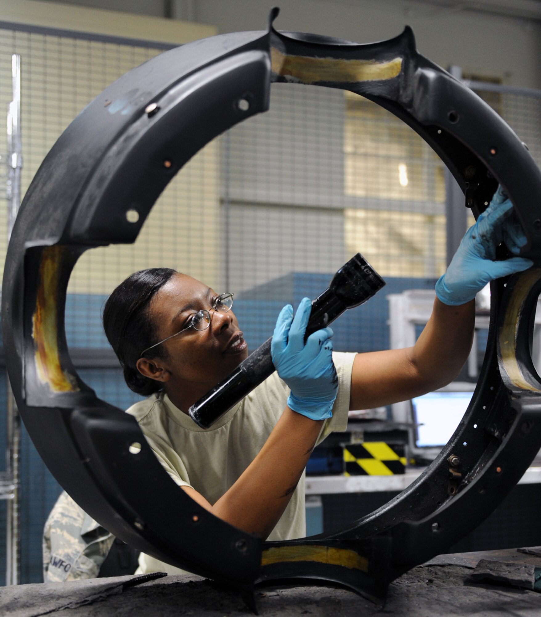 Staff Sgt. Alecia Crawford inspects a C-130 Hercules engine component for cracks May 31, 2011, at Little Rock Air Force Base, Ark.  Sergeant Crawford is an aerospace propulsion journeyman assigned to the 19th Component Maintenance Squadron. (U.S. Air Force photo/Airman 1st Class Rusty Frank)