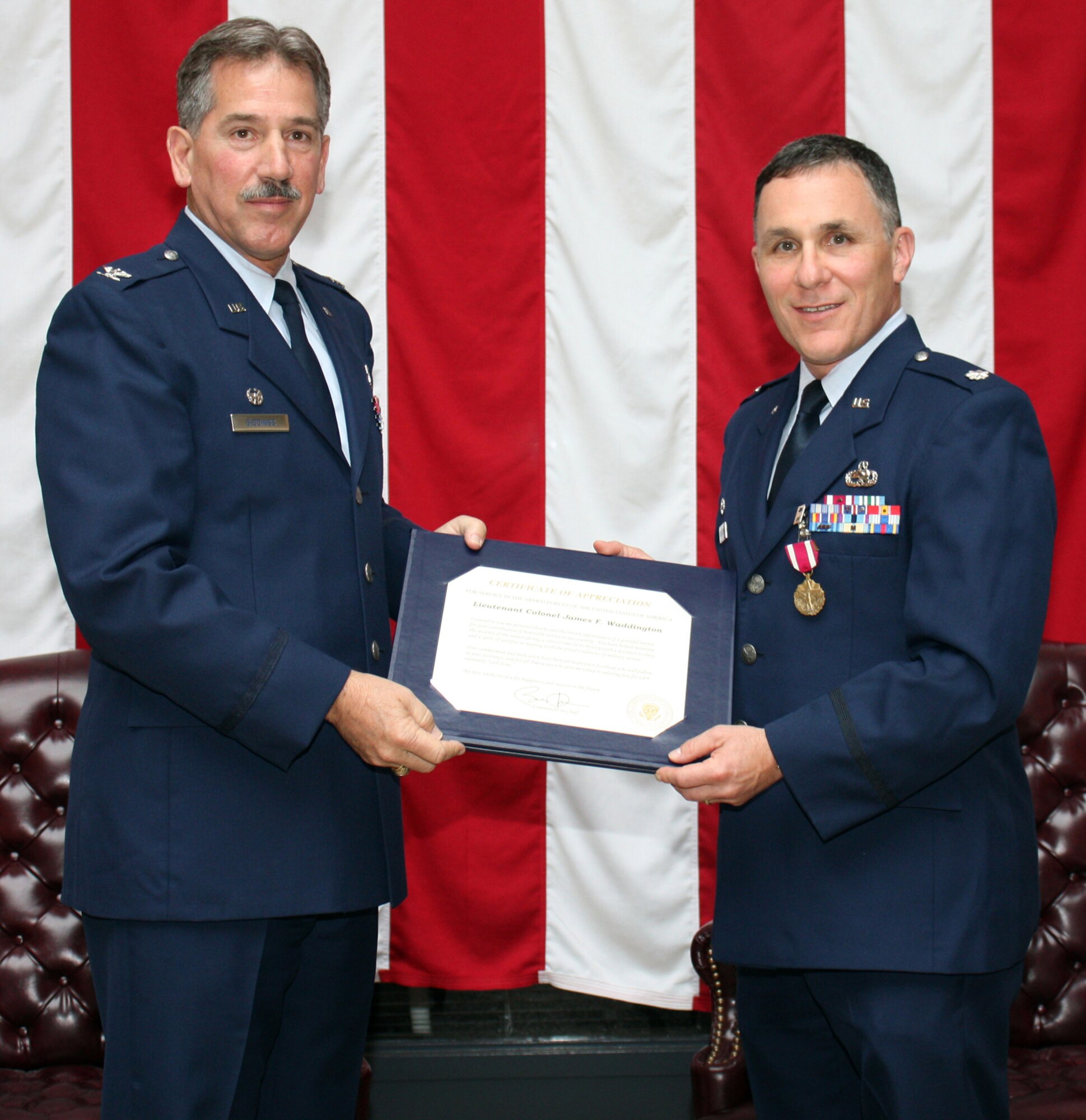 TRAVIS AIR FORCE BASE, Calif. --Lt. Col. James F. Waddington, Commander of the 349th Maintenance Squadron , receives a certification of appreciation from Col. M. J. (Sonny) Giddings, Jr. is commander of the 349th Maintenance Group, at his retirement ceremony, here, May 14. (U.S. Air Force photo/Capt. Robin Jackson)