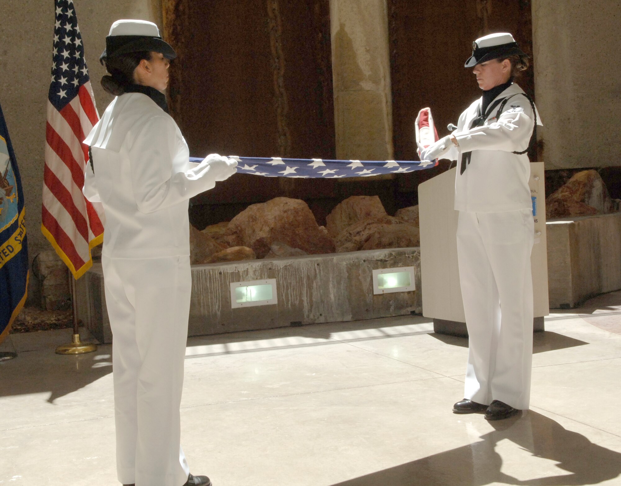 A Navy color guard from the Naval Operations Support Center in Tucson fold an American Flag during a memorial ceremony honoring the Doolittle raid and victory at the Battle of Midway June 3. (U.S. Air Force photo/Tech. Sgt. Eric Petosky)