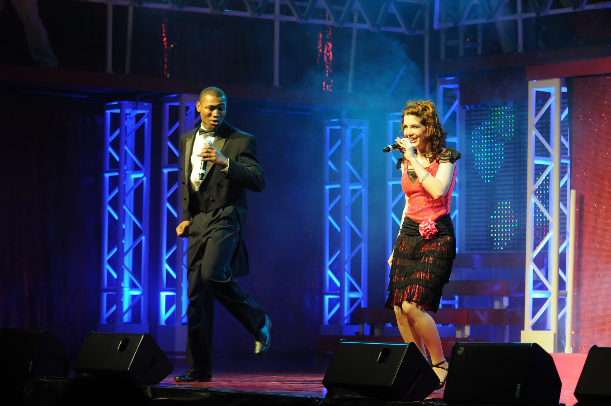 SAN ANGELO, Texas - Airmen 1st Class Jarrod Burton and Aimee Grills, members of the 2011 Tops in Blue team, perform a number together June 1 during the Rhythm Nation show at the San Angelo Coliseum. More than 1,100 people from Goodfellow and San Angelo gathered in the coliseum for the group’s free show.    This was the third stop of more than 60 locations planned for their 2011 world tour.  (U.S. Air Force photo/Staff Sgt. Heather L. Rodgers)