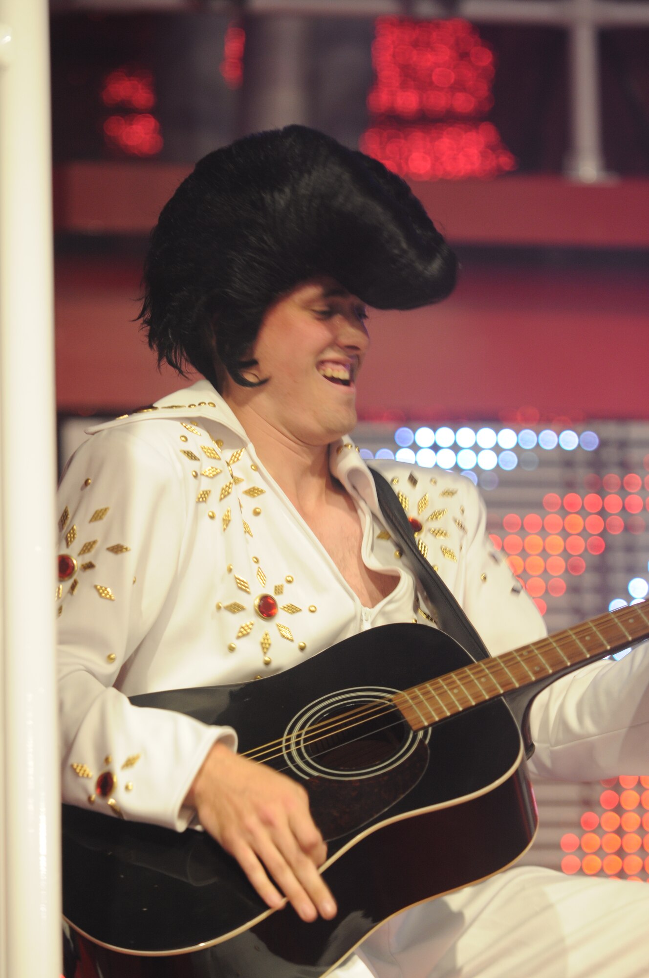 SAN ANGELO, Texas - Senior Airman Cordero Nichols, 2011 Tops in Blue member, performs as Elvis Presley June 1 during the Rhythm Nation show at the San Angelo Coliseum. More than 1,100 people from Goodfellow and San Angelo gathered in the coliseum for the group’s free performance which highlighted popular music throughout the past century.  This was the third stop of more than 60 locations planned for their 2011 world tour.  (U.S. Air Force photo/Staff Sgt. Heather L. Rodgers)
