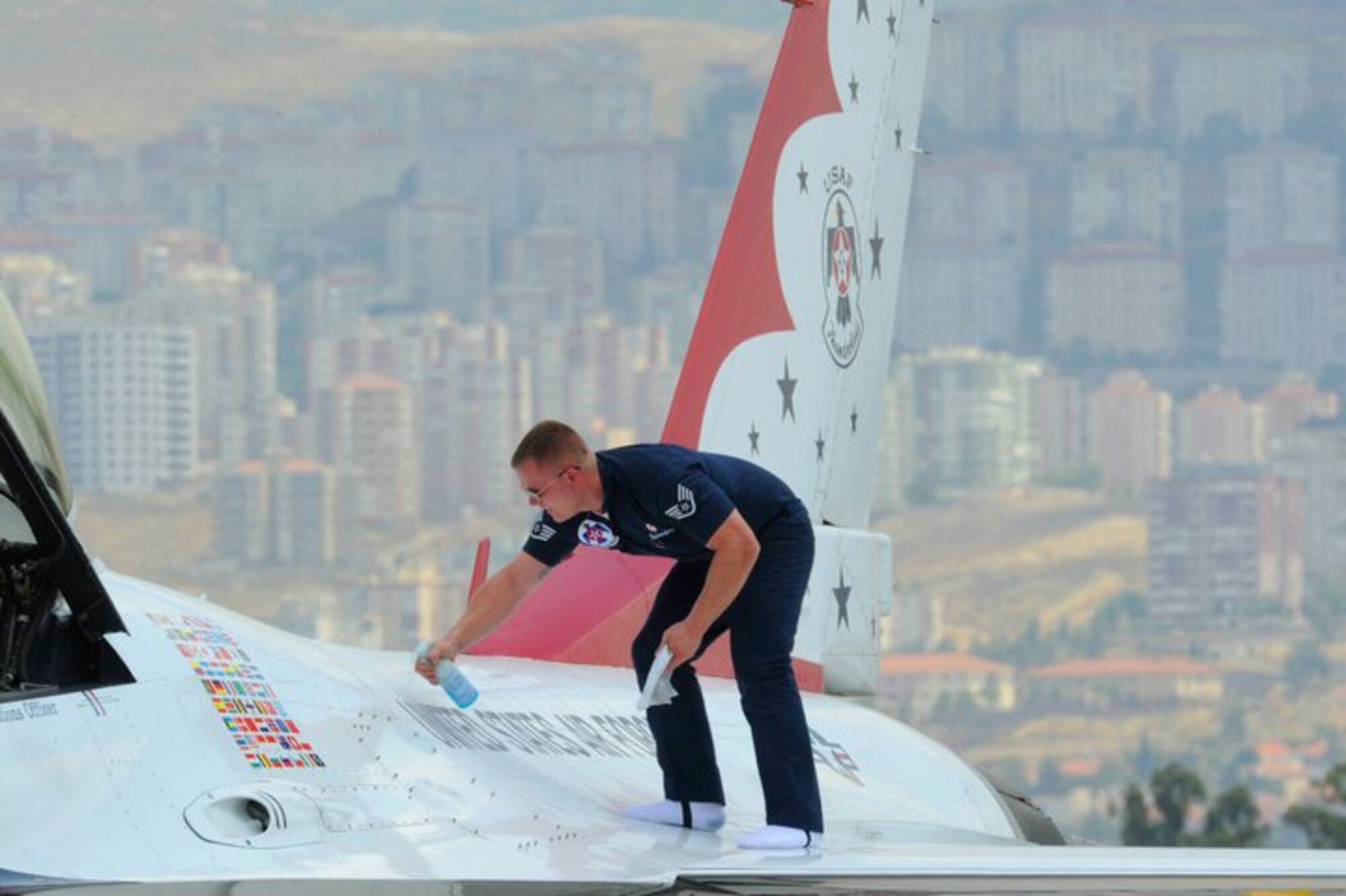 Staff Sgt. Randy Hassenplug, No. 7 assistant crew chief, cleans his jet before the Thunderbirds practice demonstration at Ciigli Air Base, Turkey, June 7, 2011. (U.S. Air Force photo by Staff Sgt. Richard Rose Jr./Released)
