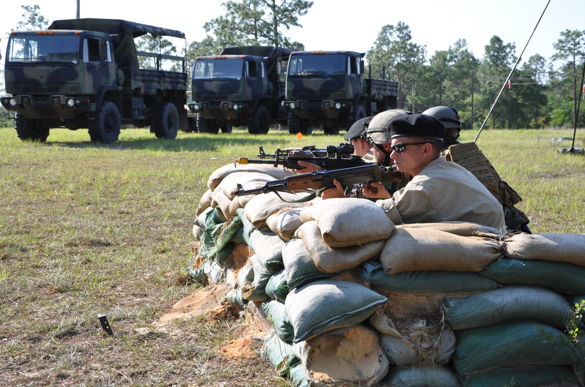 U.S. Air Force combat aviation advisor trainees and simulated partner nation forces guard the U.S. camp May 24, 2011, during exercise Raven Claw at Duke Field, Fla. Raven Claw is the capstone event for the Air Force Special Operations Training Center's Combat Aviation Advisor Mission Qualification Course. (U.S. Air Force photo by Rachel Arroyo/Released)