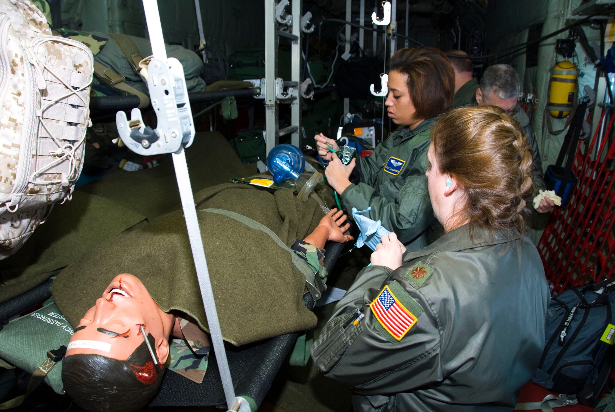 Maj. Marcia Hendrickson and Staff Sgt. Calle Harmon, 167th Aeromedical Squadron, Martinsburg, W.Va., perform in-flight training on a medical dummy while aboard a C-130 Hercules aircraft, Key West, Fla., Dec. 14. 2007. (U.S. Air Force photo by Master Sgt. Sean M. Brennan)