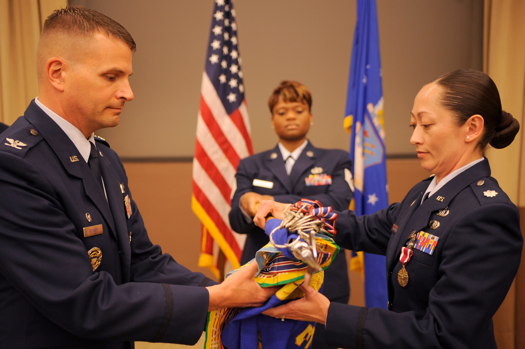 VANDENBERG AIR FORCE BASE, Calif. -- Col. Todd Gossett, the 30th Operations Group commander, and Lt. Col. Diana Hajek, the 30th Weather Squadron commander, prepare the guidon for retirement during the 30th WS Inactivation Ceremony at the 381st Training Group auditorium here Friday, June 3, 2011.  The 30th Weather Squadron became the 30th Operations Support Squadron Weather Flight. (U.S. Air Force photo/Staff Sgt. Andrew Satran) 

 