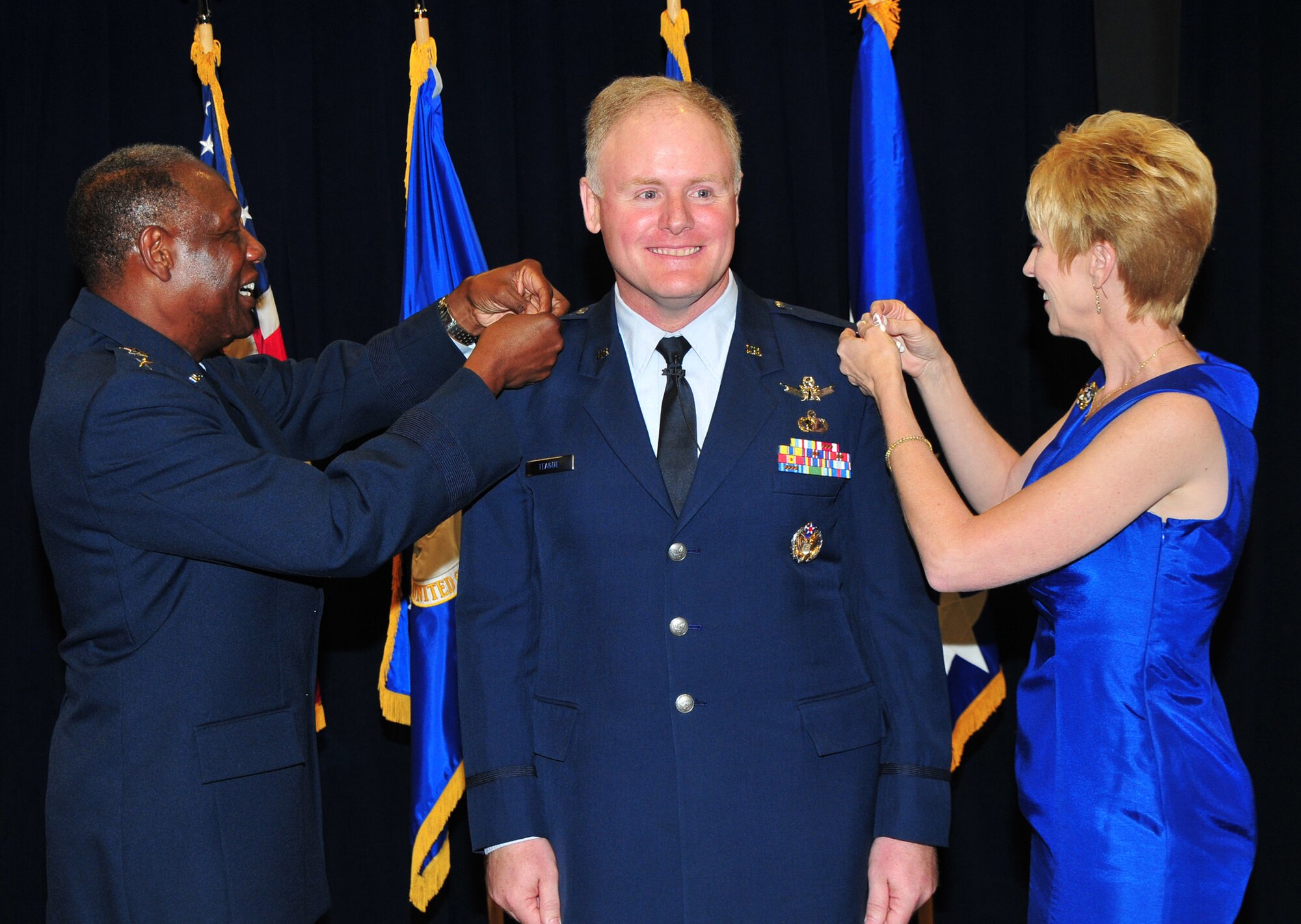 Brig. Gen. Roger Teague has his first star pinned on by his wife, Kim,  and Retired  Air Force General Lester Lyles at a promotion ceremony held here, June 2.  Currently the Infrared Space Systems director, Brig. Gen. Teague has been named as SMC’s vice commander.  (Photo by Lou Hernandez)