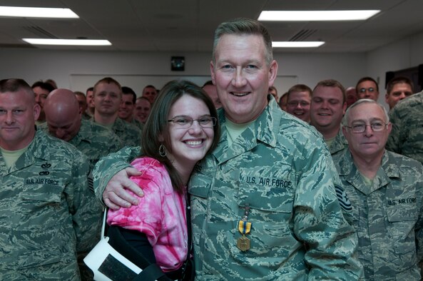 Tech. Sgt. Roy L. Akers, a civil engineer with the 130th Civil Engineering Squadron, 130th Airlift Wing, Charleston, W.Va., and Ashley N. Parker, a civilian, pose for a picture in front of the 130th CES formation during an awards ceremony, Feb. 6. Tech. Sgt. Akers received the Air Force Commendation Medal for his actions on Aug. 13, 2010, in which he saved Parker’s life. (U.S. Air Force photo by Tech. Sgt. Eugene R. Crist) 