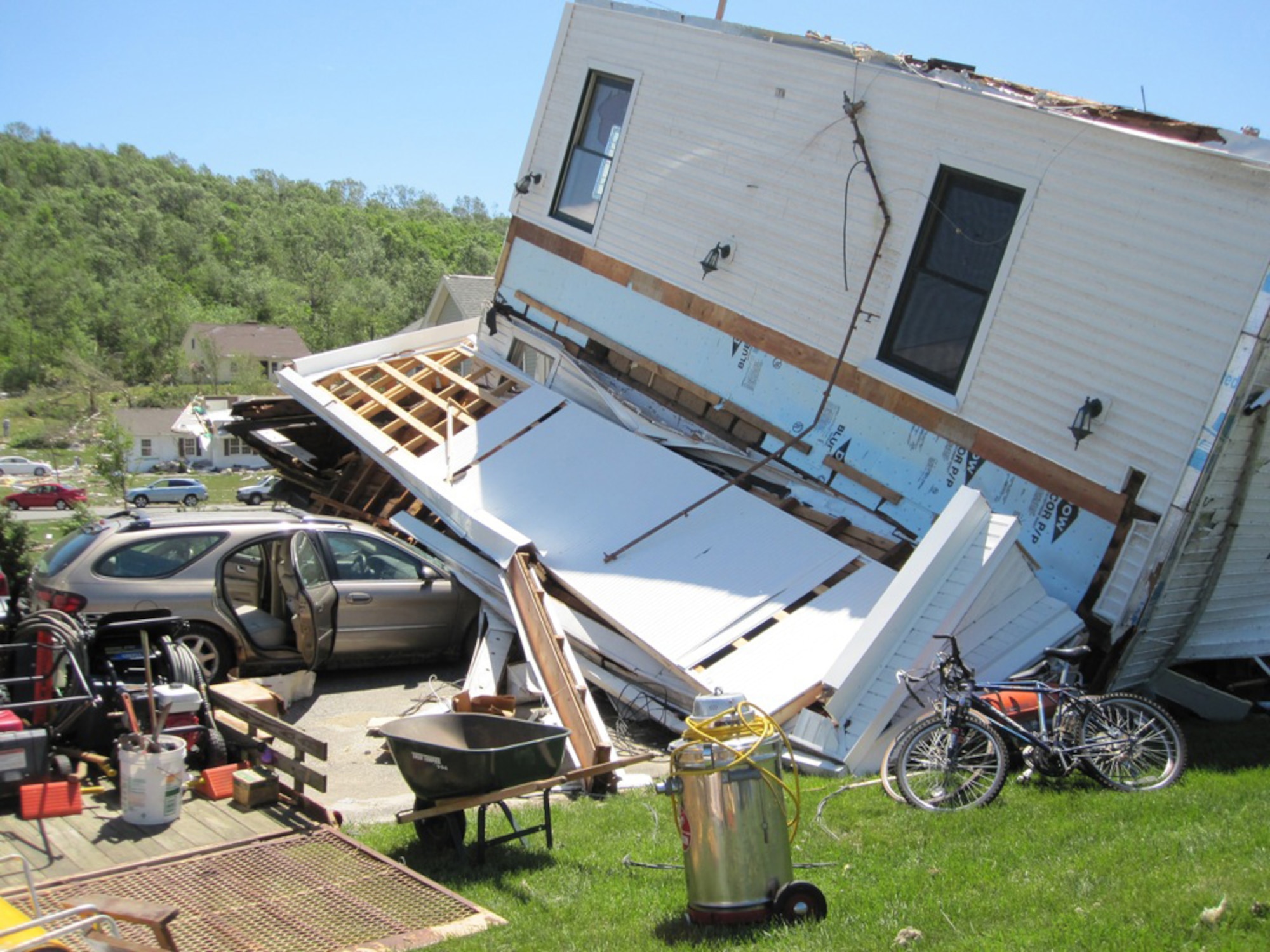 A home and belongings in Monson, Mass., show the aftermath of a tornado that ripped through the area June 1, 2011. Firefighters from Westover Air Reserve Base, Mass., performed search and rescue the next day in Monson after two tornadoes left widespread damage in 19 communities across the area. (Courtesy photo/Capt. Robert Mancini)
					