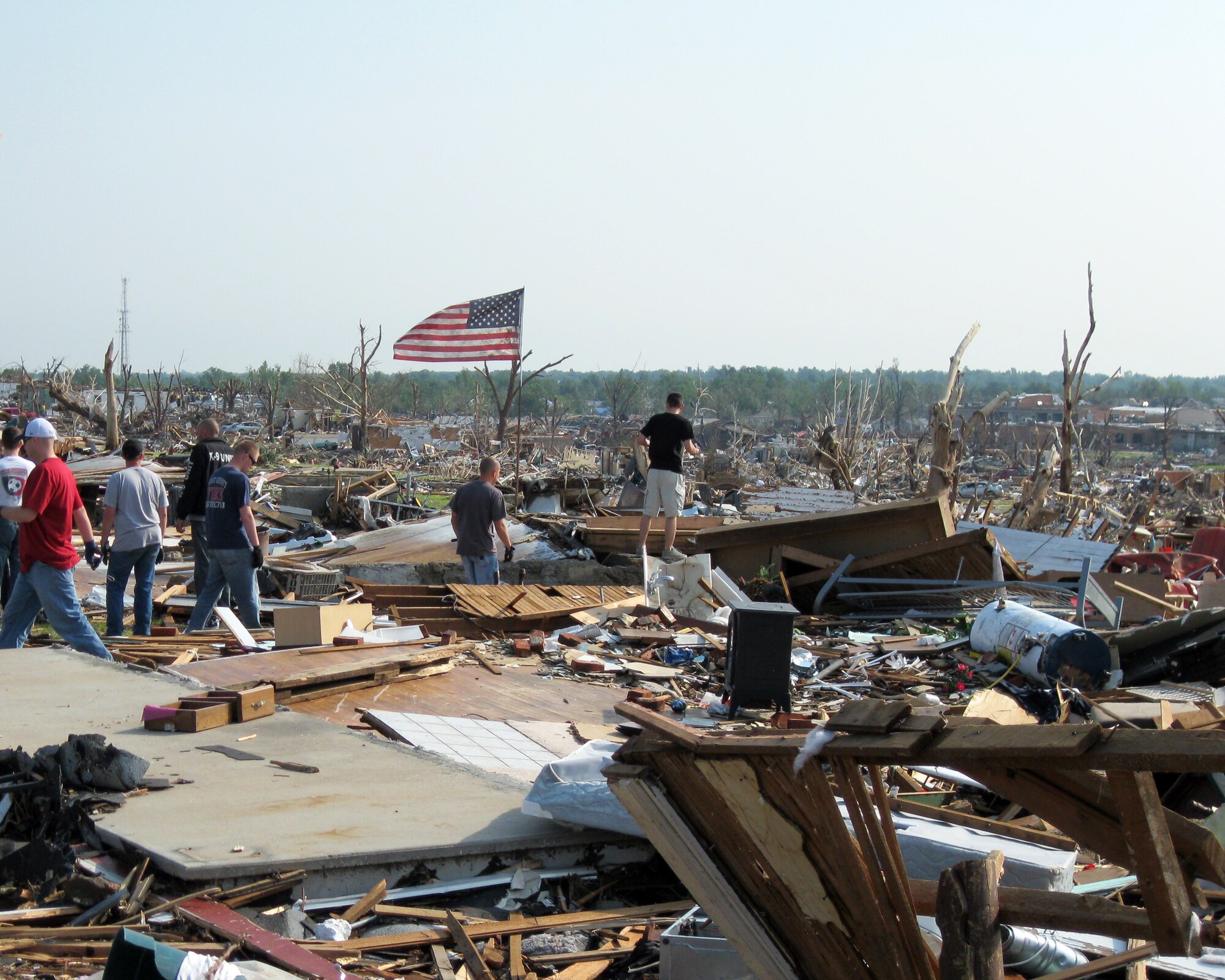Volunteers from Altus Air Force Base and residents of Joplin, Mo., search through the rubble of the devastated city for survivors and personal belongings May 28, 2011. Joplin was hit by a tornado May 22. (Courtesy photo)