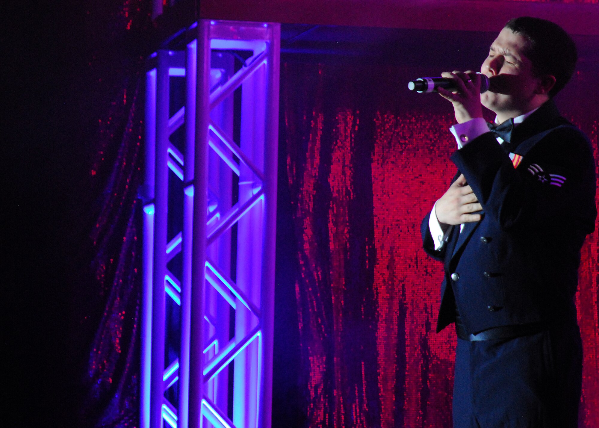 SAN ANGELO, Texas-- Senior Airman Zachery Rayburn, Tops in Blue 2011 vocalist, sings to a crowd of more than 1,100 gathered at the San Angelo Coliseum June 1 for the Tops in Blue Rhythm Nation show. San Angelo was the third stop on the group's 2011tour list, which includes a variety of stateside bases, Europe, and even Asia. The show was free and open to the public.  (U.S. Air Force photo/Airman 1st Class Michael Smith) 