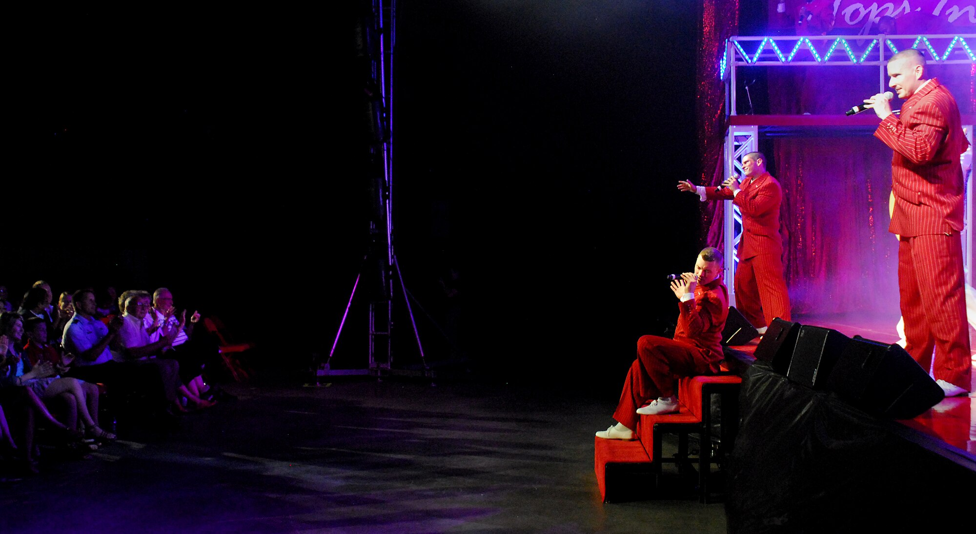 SAN ANGELO, Texas-- (From right) Tech. Sgt. Douglas Boren, Senior Airman Patrick O’shaughnessy, and 1st Lt. Robert Doyle, Tops in Blue 2011 vocalists, get together to perform at the San Angelo Coliseum June 1 for the group's Rhythm Nation show. San Angelo was the third stop on their 2011 tour list, which includes a variety of stateside bases, Europe, and even Asia. The show was free and open to the public.  (U.S. Air Force photo/Airman 1st Class Michael Smith) 