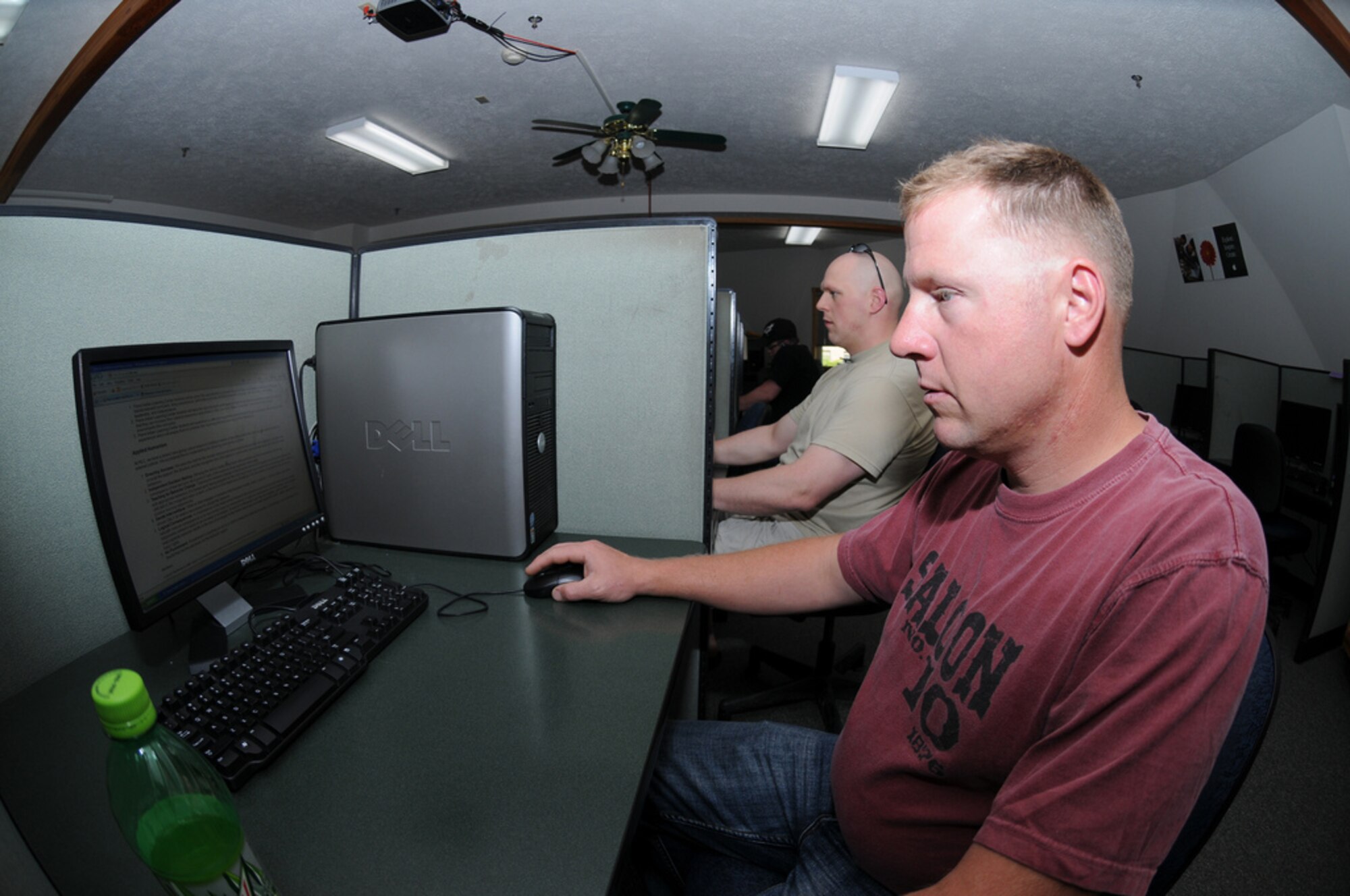PIERRE, S.D. -- Master Sgt. Eric Wollan, right, from the 114th Fighter Wing Safety office, and Staff Sgt. Joe Wiskur, from the 114th Fighter Wing Aviation Resource Management office, browse the internet while off duty at the Pierre Indian Learning Center Internet Cafe Wednesday, June 1, 2011.The Center opened the campus for 650 Soldiers and Airmen who have been activated as part of flood relief efforts along the Missouri River. (SDNG photo by Capt. Michael Frye) (RELEASED)
