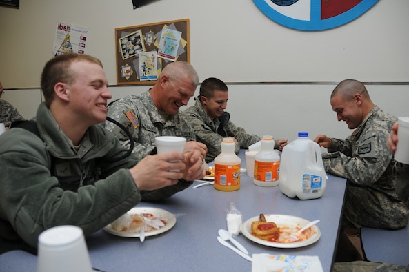 PIERRE, S.D. -- Soldiers and Airmen from the South Dakota National Guard visit during breakfast at the Pierre Indian Resource Center here Thursday, June 2, 2011. Pictured from left to right are Airmen First Class Todd Suurmeyer, Staff Sgt. James Reinhardt, Airman First Class Casey Schoellerman, and Cadet Peter Bendorf. Suurmeyer and Schoellerman are both crew chiefs with the South Dakota Air National Guard, while Reinhardt and Bendorf are both from the 1st/147th HHB. The Center opened the campus for 650 Soldiers and Airmen who have been activated as part of flood relief efforts along the Missouri River. (SDNG photo by Capt. Michael Frye) (RELEASED)
