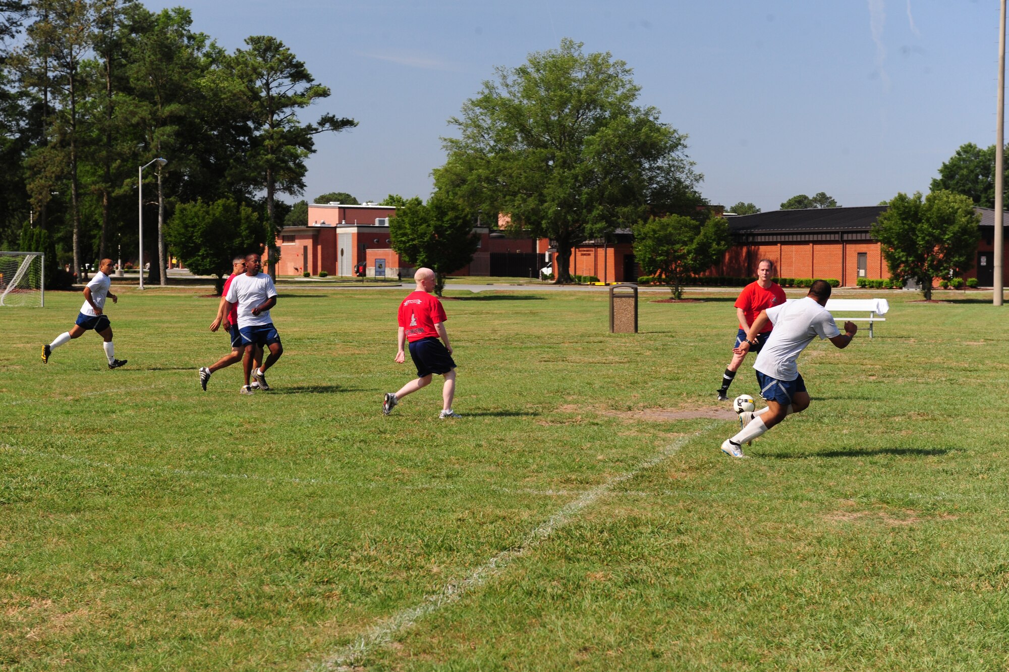 SEYMOUR JOHNSON AIR FORCE BASE, N.C. - Airmen from the 333rd Fighter Squadron (Red Shirts) and 4th Equipment Maintenance Squadron (physical training uniform) compete in a co-ed soccer tournament during Wing Sports Day here, June 3, 2011. Both the 333rd FS and the 4th EMS had two teams in the soccer tournament. (U.S. Air Force photo/Senior Airman Rae Perry) (RELEASED)