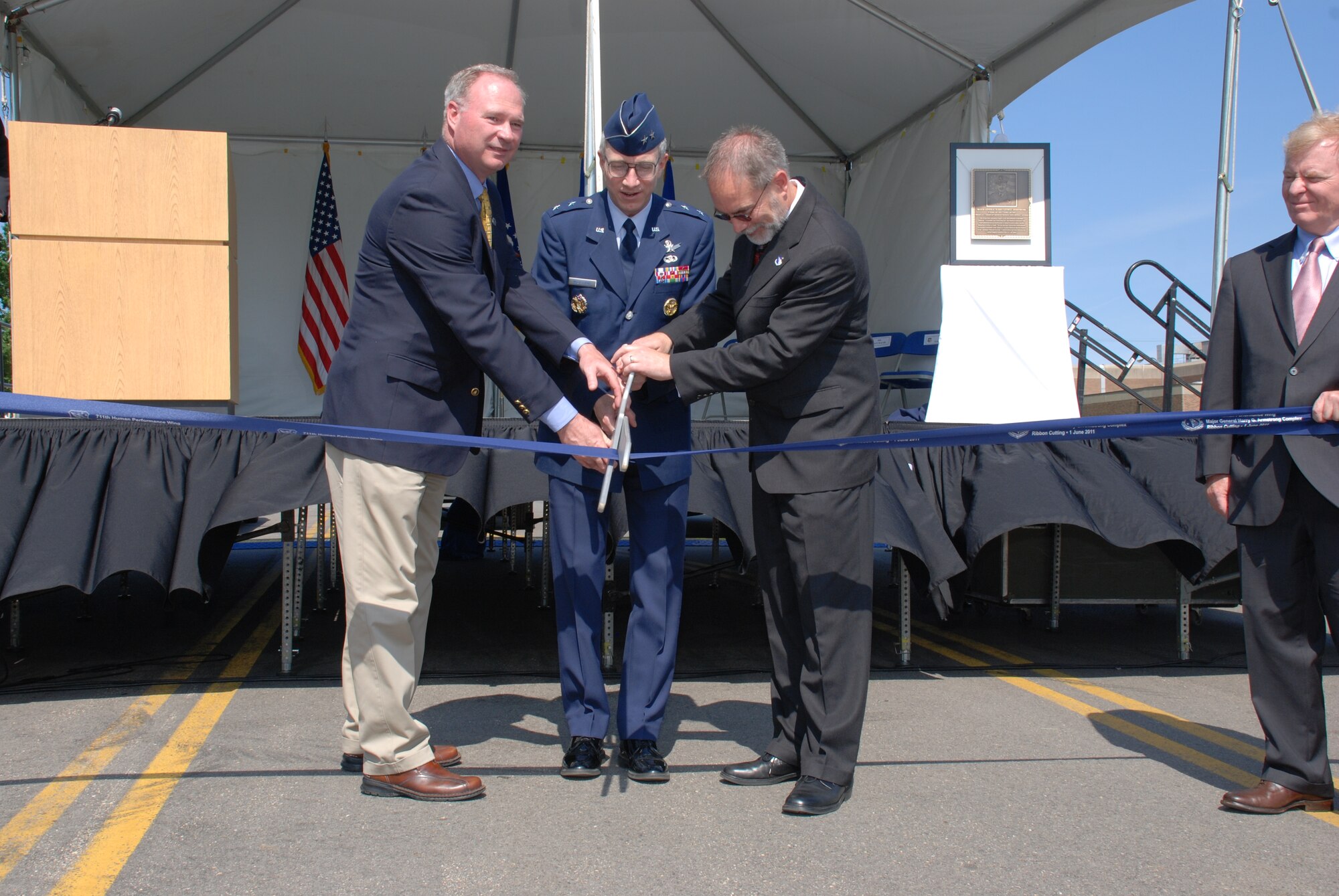 Mr. Dan France, Chief of Plans and Programs for the 88th Air Base Wing and the Installation BRAC Director, Major General William McCasland, Air Force Research Laboratory Commander, and Mr. Thomas Wells, 711 711th Human Performance Wing Director, cut the ribbon to officially open the Wing’s (711 HPW’s) new complex, named in honor of United States Air Force Major General Harry G. Armstrong, a pioneer in the field of aerospace research. Mr. Dan Walsh, who represented the joint venture of Butt Construction and Archer Western Contractor (far right) holds the ribbon. (U.S. Air Force photo by Chris Gulliford)