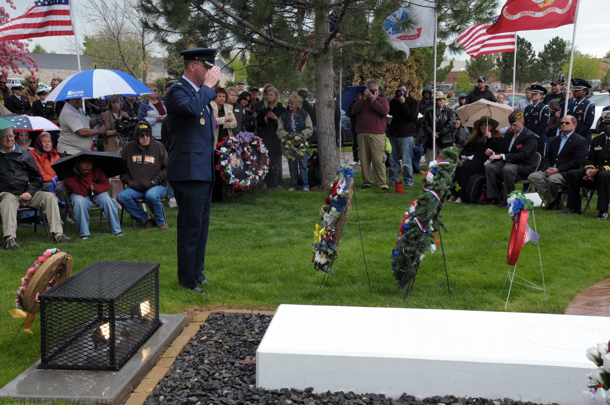 Col. Scott Fox, 90th Missile Wing vice commander, salutes wreaths representing each branch of the military in respect for those members of the American military who paid for freedom with their lives during a Memorial Day wreath-laying ceremony at Beth El Cemetery May 30. Members representing each branch of the Armed Forces, along with members of the Cheyenne community from numerous veteran’s and civic groups, joined together and laid wreaths at a grave site representing unknown soldiers who died in service. (U.S. Air Force photo by Blaze Lipowski)