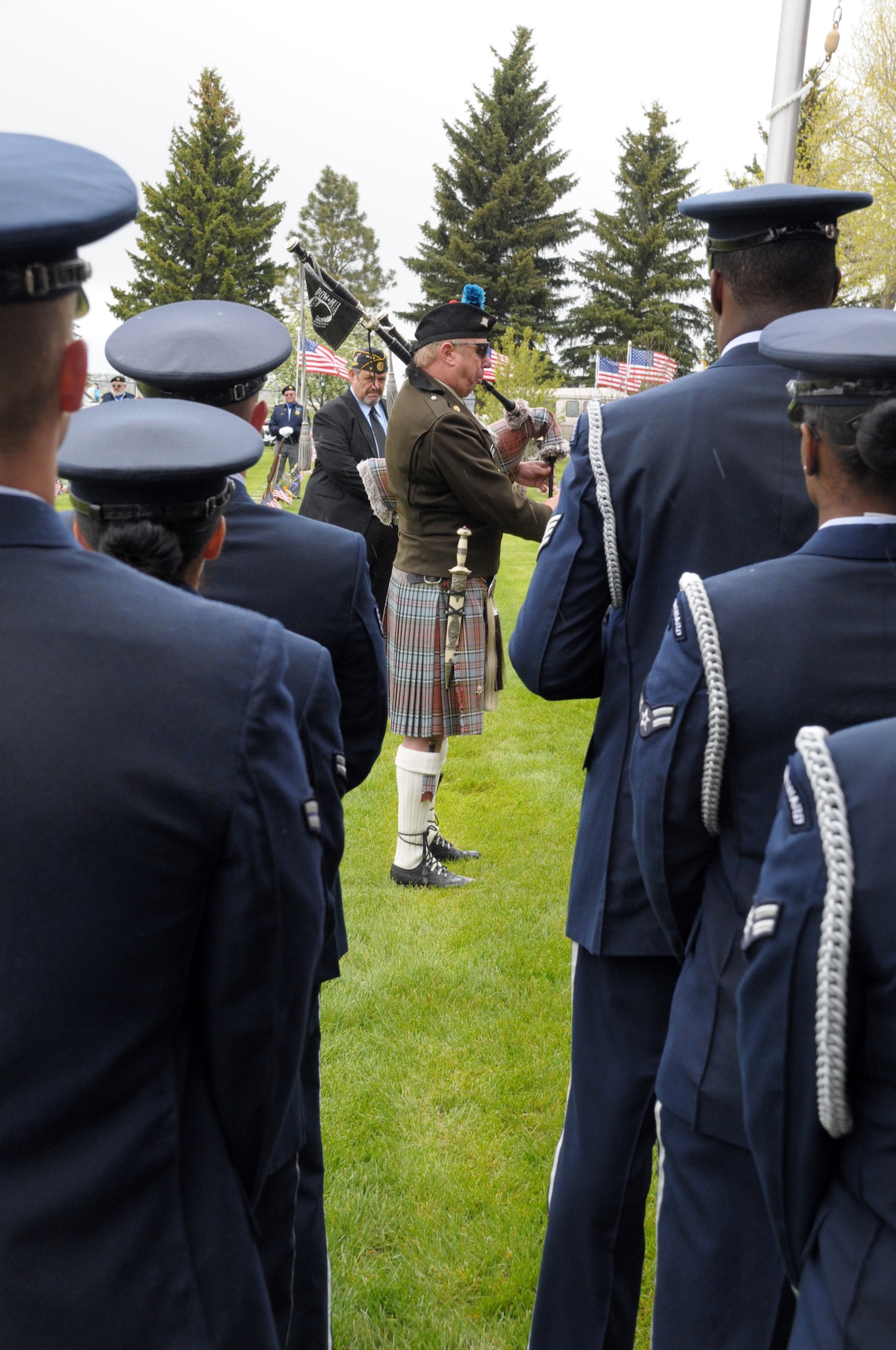 Members of Warren’s Honor Guard prepare to perform a flag folding ceremony as a Cheyenne area veteran plays Amazing Grace on bagpipes during a wreath-laying ceremony at Beth El Cemetery in Cheyenne, Wyo., May 30 for Memorial Day. (U.S. Air Force photo by Blaze Lipowski)