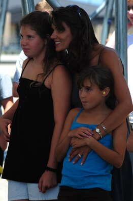 Kelly, Julianna and Isabella DeMaso wait for the arrival of their husband and father Col.  William DeMaso, 23rd Wing vice commander, to return from his final flight at Moody Air Force Base, Ga. June 2. Family and friends gathered around to congratulate Colonel DeMaso on his last flight and his 24 years of service. (U.S. Air Force photo/Senior Airman Stephanie Mancha)(RELEASED)