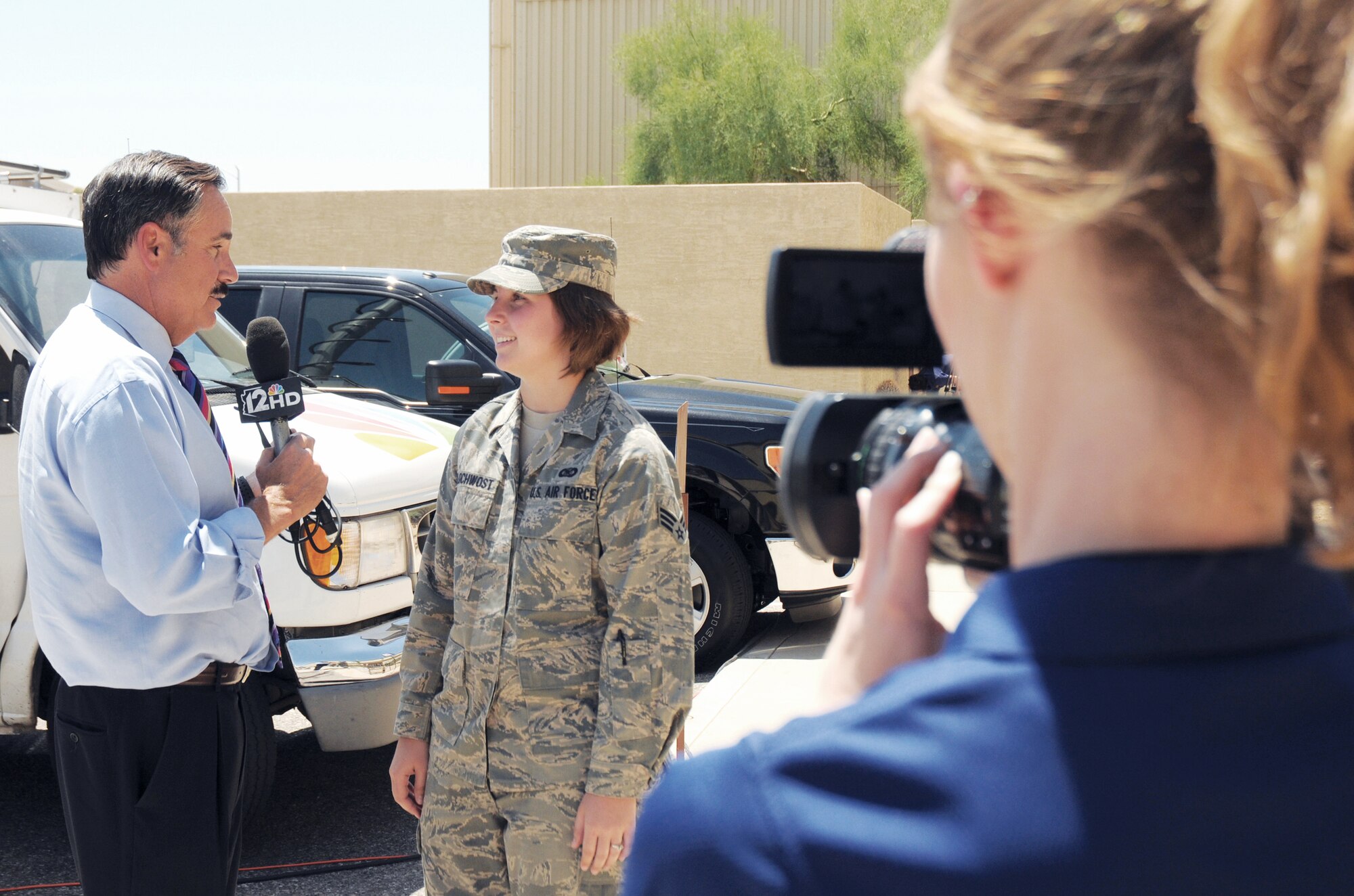 Mark Curtis, Channel 12 news anchor, interviews Senior Airman Melanie Holochwost, 56th Fighter Wing Public Affairs specialist, after their "dog fight," a form of aerial combat between fighter aircraft, in the F-16 simulators May 25 at Luke Air Force Base, Ariz.  Mr. Curtis visited several locations at Luke as a part of Channel 12's 24-hour all-access pass.  Thirteen clips aired May 24 and May 25, informing the local community that F-16 pilots are just one element of Luke's mission.  Without maintainers, life support technicians, air traffic controllers and other "behind-the-scenes" Airmen, pilots wouldn't be able to do their jobs safely and effectively. To view the coverage, visit www.azcentral.com/12news/news/articles/2011/05/25/20110525luke-air-force-base-mark-curtis.html.  (U.S. Air Force photo by Staff Sgt. Denise Willhite) (The appearance of hyperlinks does not constitute endorsement by the 56th Fighter Wing, the United States Air Force, or the Department of Defense of the external Web site, or the information, products, or services contained therein. For other than authorized activities such as military exchanges and Services/Morale, Welfare and Recreation (MWR) sites, the United States Air Force does not exercise any editorial control over the information you may find at these locations. Such links are provided consistent with the stated purpose of the Web site.)