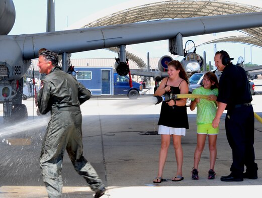 Col. William DeMaso, 23rd Wing vice commander, gets hosed down by his daughter on the left Julianna, 11, at Moody Air Force Base, Ga. June 2. Col DeMaso will be retiring after 24 years of service. (U.S. Air Force photo/Senior Airman Stephanie Mancha)(RELEASED) 