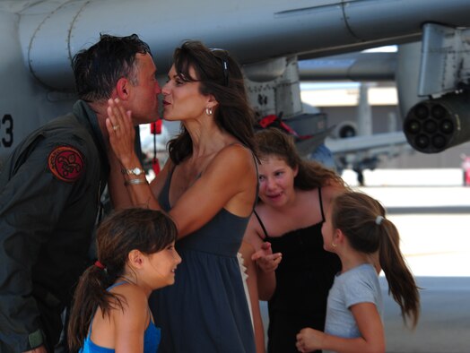 Col. William DeMaso, 23rd Wing vice commander, and wife Kelly share a moment after his return from his final flight on an A-10C Thunderbolt II at Moody Air Force Base, Ga.  June 2. The final or “fini” flight is a long-standing Air Force tradition that traces its roots back to the Vietnam War where pilots would commemorate their final mission. (U.S. Air Force photo/Senior Airman Stephanie Mancha)(RELEASED)
