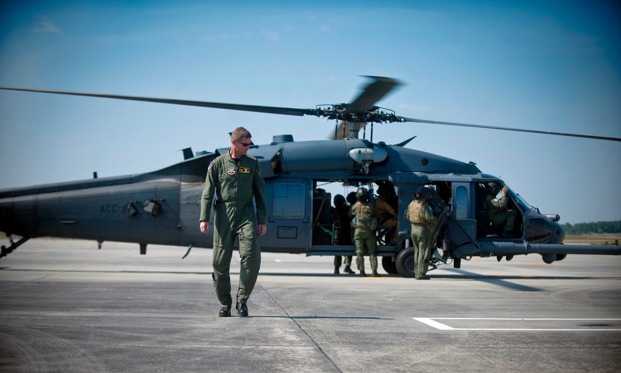 MOODY AIR FORCE BASE, Ga.--  Col. Gary Henderson, 23rd Wing commander, walks away from an HH-60G Pave Hawk after helping Général de Division Aérienne (Maj. Gen.) Gratien Maire, French defense attaché to the U.S., strap into his seat before a flight during his base visit June 2. General Maire visited to experience what life is like for the two French exchange pilots currently serving with Moody units. (U.S. Air Force photo/Airman 1st Class Joshua Green)(RELEASED)
