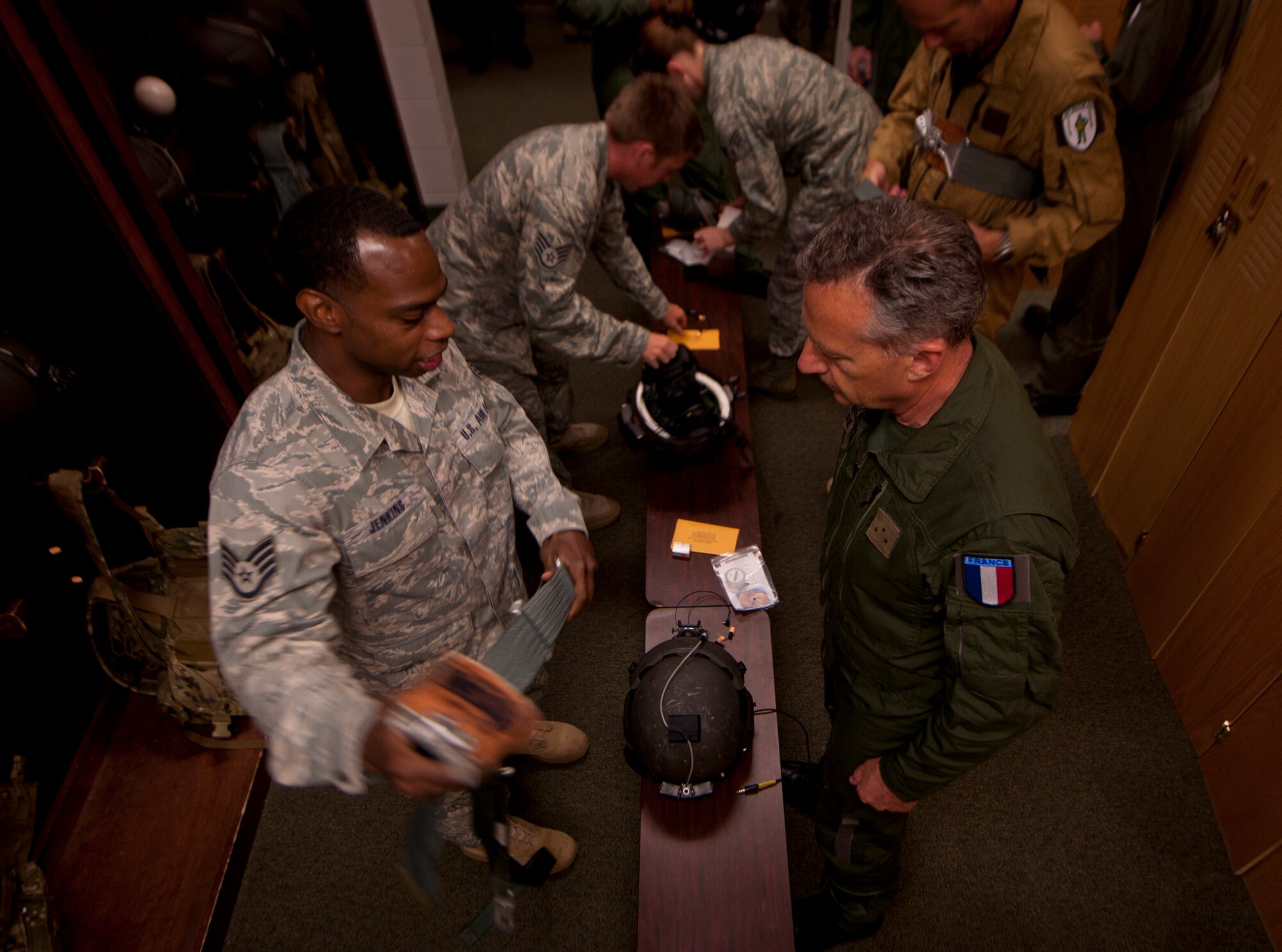 MOODY AIR FORCE BASE, Ga.--  Staff Sgt. Henry Jenkins, 41st Rescue Squadron aircrew flight equipment craftsman, gives Général de Division Aérienne (Maj. Gen.) Gratien Maire, French defense attaché to the U.S., instruction on how to adjust his gunner’s belt before an HH-60G Pave Hawk flight during a base visit June 2. (U.S. Air Force photo/Airman 1st Class Joshua Green)(RELEASED)  
 
