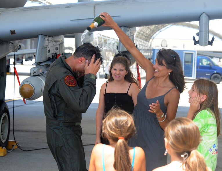 Col. William DeMaso, 23rd Wing vice commander, and his family celebrate his final flight at Moody Air Force Base, Ga., June 2. Colonel DeMaso’s family gave him a traditional  champagne bath (U.S. Air Force photo/Airman 1st Class Paul Francis)(RELEASED)