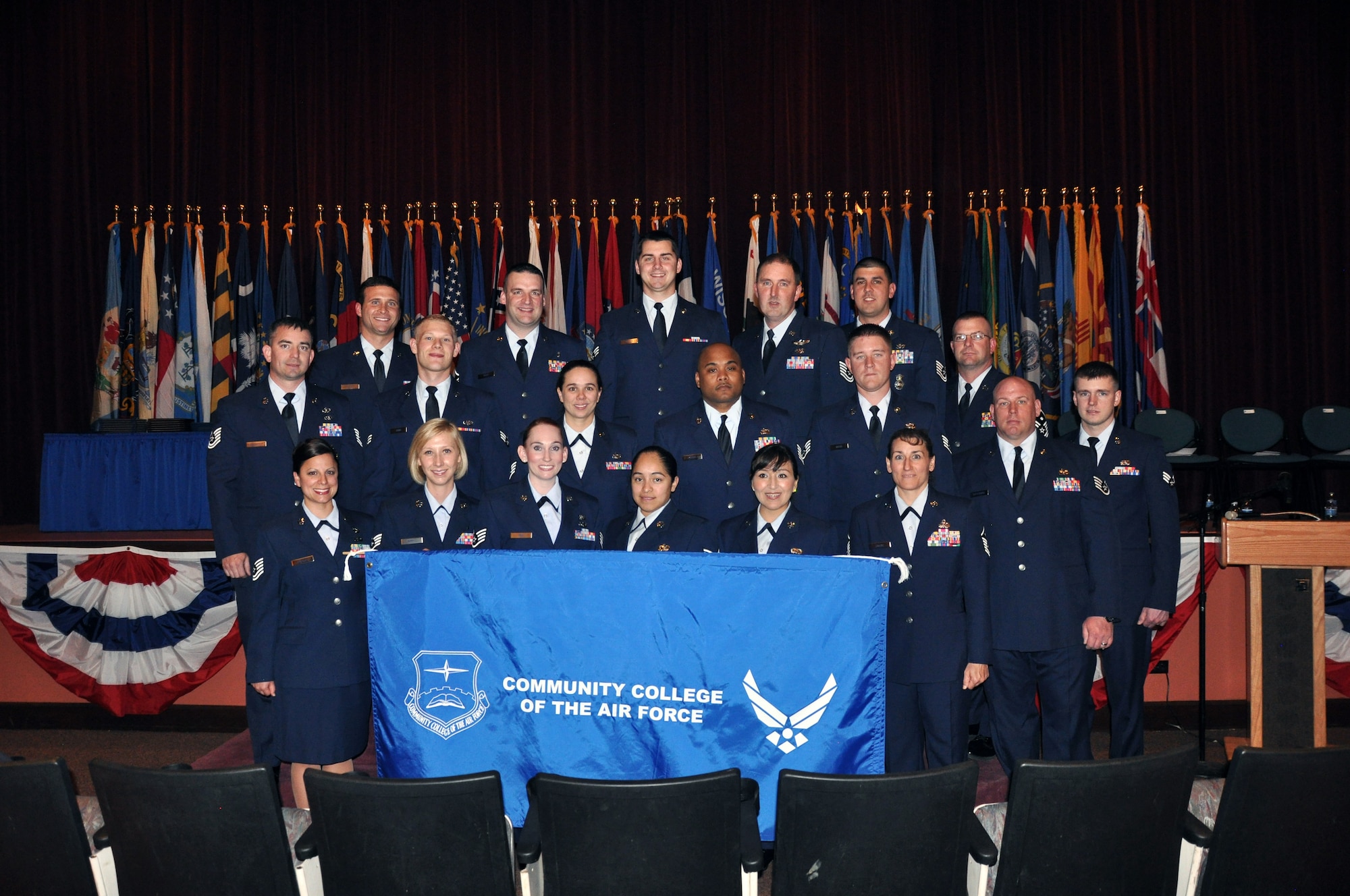 Members of Warren's 2011 Community College of the Air Force graduating class pose for a group photo after walking across the stage Wednesday in the Base Theatre. (Courtesy photo)