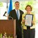 State Representative Brad Bennett presents a Proclamation from the State of Delaware to Alice Witterholt, past president, Delaware Federal of Garden Clubs. (U.S. Air Force photo Roland Balik)