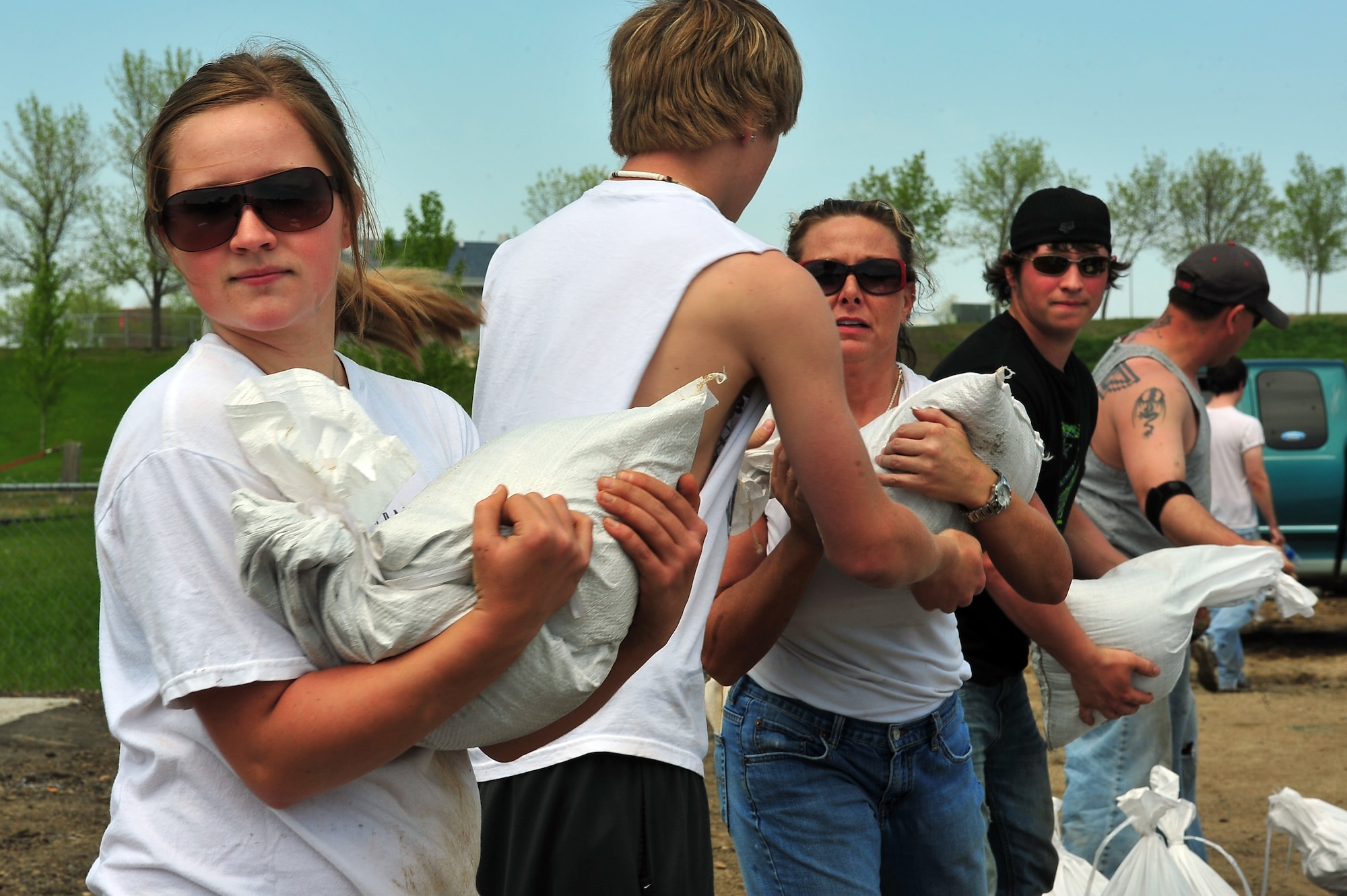 Airmen and local citizens work together to make sandbags at the Minot Public Works June 1, 2011, in Minot, N.D. In preparation for possible flooding, the city of Minot, with assistance from Airmen from Minot Air Force Base, North Dakota National Guard as well as many other organizations, are setting up secondary dikes along the river. The Souris River threatens to break the levies already in place, thousands of Minot citizens, including military members, their families and DOD civilians, have been forced to evacuate the area. (U.S. Air Force photo/Senior Airman Jesse Lopez)