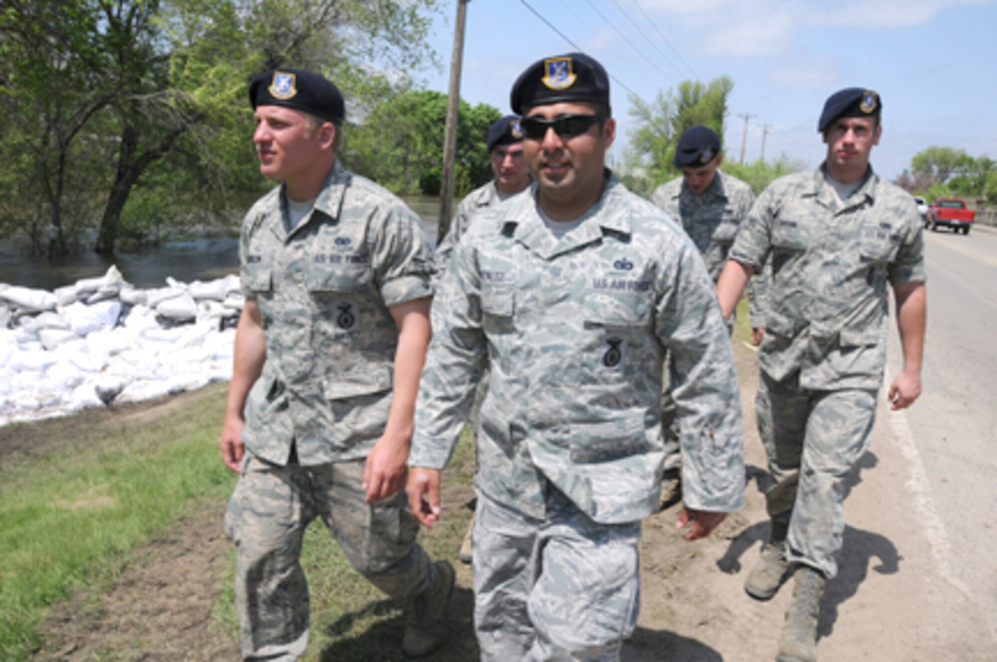 Master Sgt. Frank Gonzalez leads a team on a presence patrol mission June 2, 2011, throughout a low-lying area of Minot, N.D. To his left is Airman 1st Class Cody Jenson and, to the right, Airman 1st Class Alex Sprunk. North Dakota Guardsmen are spread throughout the evacuated areas of Minot in two- to six-person teams to guard against theft or vandalism since homeowners evacuated due to the flooding Souris River. Sergeant Gonzalez is assigned to the North Dakota Air National Guard's 219th Security Forces Squadron. (U.S. Air Force photo/Senior Master Sgt. David H. Lipp)