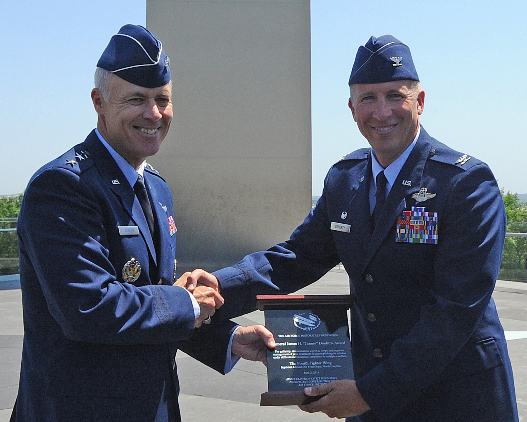 ARLINGTON, Va. -- U.S. Air Force Assistant Vice Chief of Staff Lt. Gen. Richard Newton III, presents Col. Patrick Doherty, 4th Fighter Wing commander, with the inaugural Doolittle Award at the Air Force Memorial June 2, 2011. The Air Force Historical Foundation Doolittle Award recognizes a unit that has displayed bravery, determination, discipline, esprit de corps, and superior management of joint operations while accomplishing its mission under extremely difficult and hazardous conditions in multiple conflicts, making a sustained, significant contribution to Air Force history. (U.S. Air Force photo/Senior Airman Gino Reyes)
