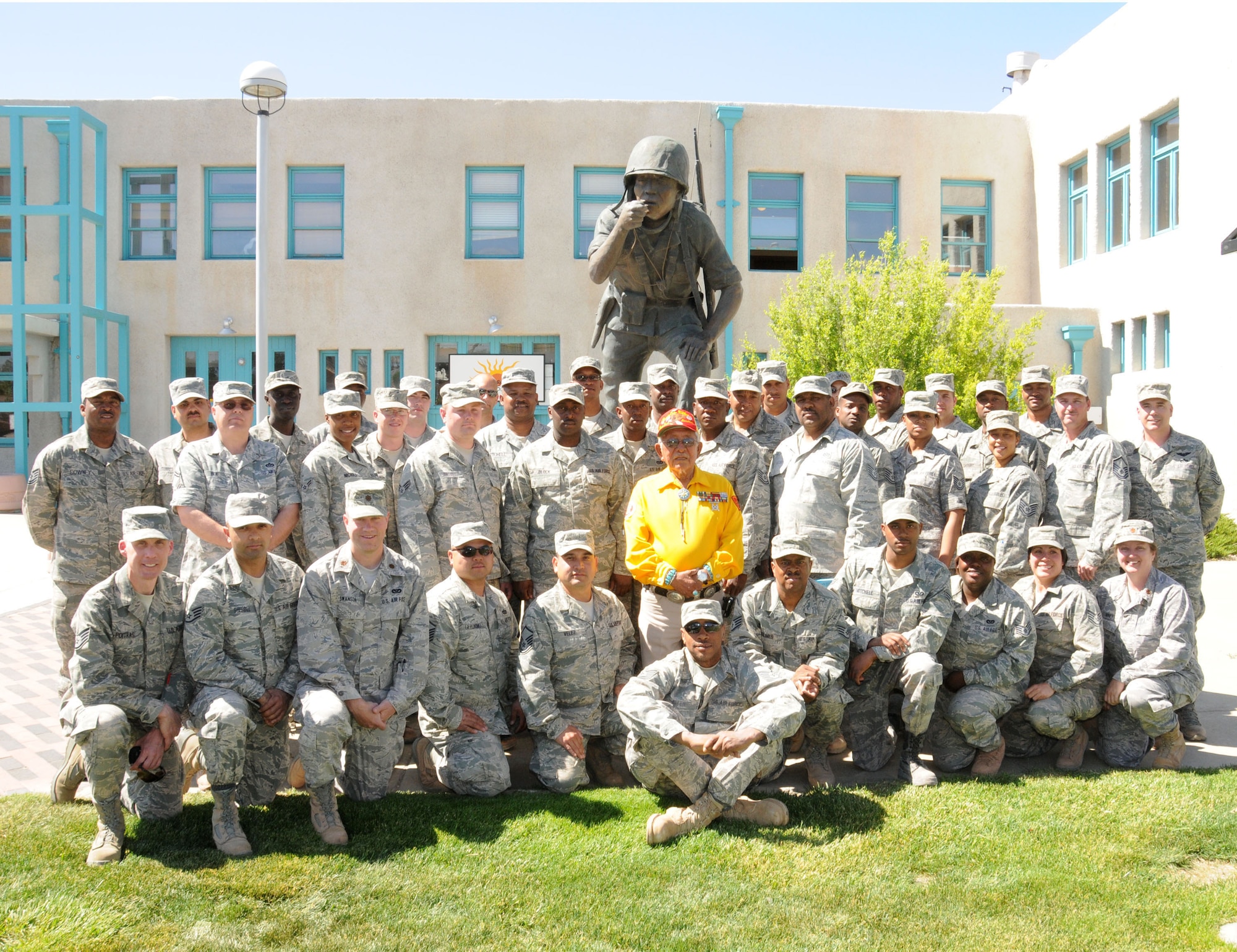 Members of the 113th Civil Engineer Squadron (113th CES), District of Columbia Air National Guard, pose with Bill Toledo, an original Navajo "Code-Talker" from World War II, following a speech by Toledo in which Toledo relayed his experiences during the war.  The 113th CES members are in Window Rock, Ariz., as part of the Innovative Readiness Training, a civil-military affairs program linking military units with civilian communities for humanitarian projects.  (U.S. Air Force Photo by Tech Sgt. Craig Clapper)   
