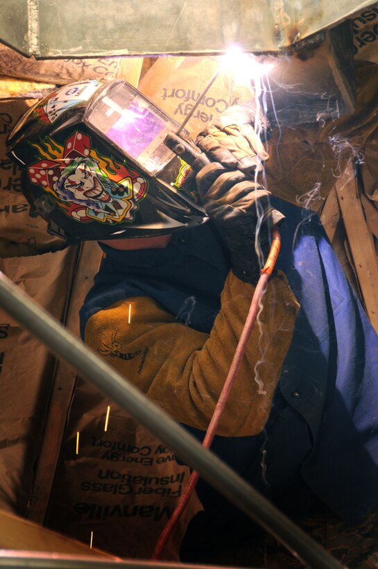 Staff Sgt. Daniel Ginevan, a welder for the 113th Civil Engineer Squadron (113th CES), District of Columbia Air National Guard, welds a roof truss support as part of a building rehabilitation project in Window Rock, Ariz., June 1, 2011.  The 113th CES members are in Window Rock, Ariz., as part of the Innovative Readiness Training, a civil-military affairs program linking military units with civilian communities for humanitarian projects.  (U.S. Air Force Photo by Tech Sgt. Craig Clapper)   