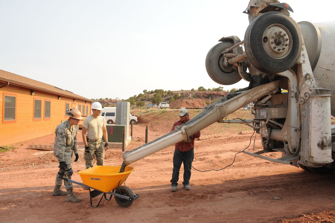 Members of the 113th Civil Engineer Squadron (113 CES), District of Columbia Air National Guard, pour cement during a humanitarian rebuilding effort in Window Rock, Ariz., June 1, 2011.  The 113th CES members are in Window Rock as part of the Innovative Readiness Training, a civil-military affairs program linking military units with civilian communities for humanitarian projects.  (U.S. Air Force Photo by Tech Sgt. Craig Clapper)   