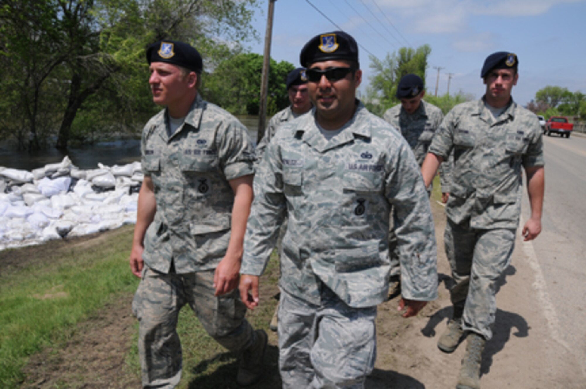 MINOT, N.D. -- Master Sgt. Frank Gonzalez, with the North Dakota Air National Guard's 219th Security Forces Squadron, leads a team on a presence patrol mission throughout a low-lying area of Minot, N.D. To his left is Airman 1st Class Cody Jenson and, to the right, Airman 1st Class Alex Sprunk. North Dakota Guardsmen are spread throughout the evacuated areas of Minot in two- to six-person teams to guard against theft or vandalism since homeowners evacuated due to the flooding Souris River. (DoD photo/Senior Master Sgt. David H. Lipp) 

