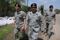 MINOT, N.D. -- Master Sgt. Frank Gonzalez, with the North Dakota Air National Guard's 219th Security Forces Squadron, leads a team on a presence patrol mission throughout a low-lying area of Minot, N.D. To his left is Airman 1st Class Cody Jenson and, to the right, Airman 1st Class Alex Sprunk. North Dakota Guardsmen are spread throughout the evacuated areas of Minot in two- to six-person teams to guard against theft or vandalism since homeowners evacuated due to the flooding Souris River. (DoD photo/Senior Master Sgt. David H. Lipp) 

