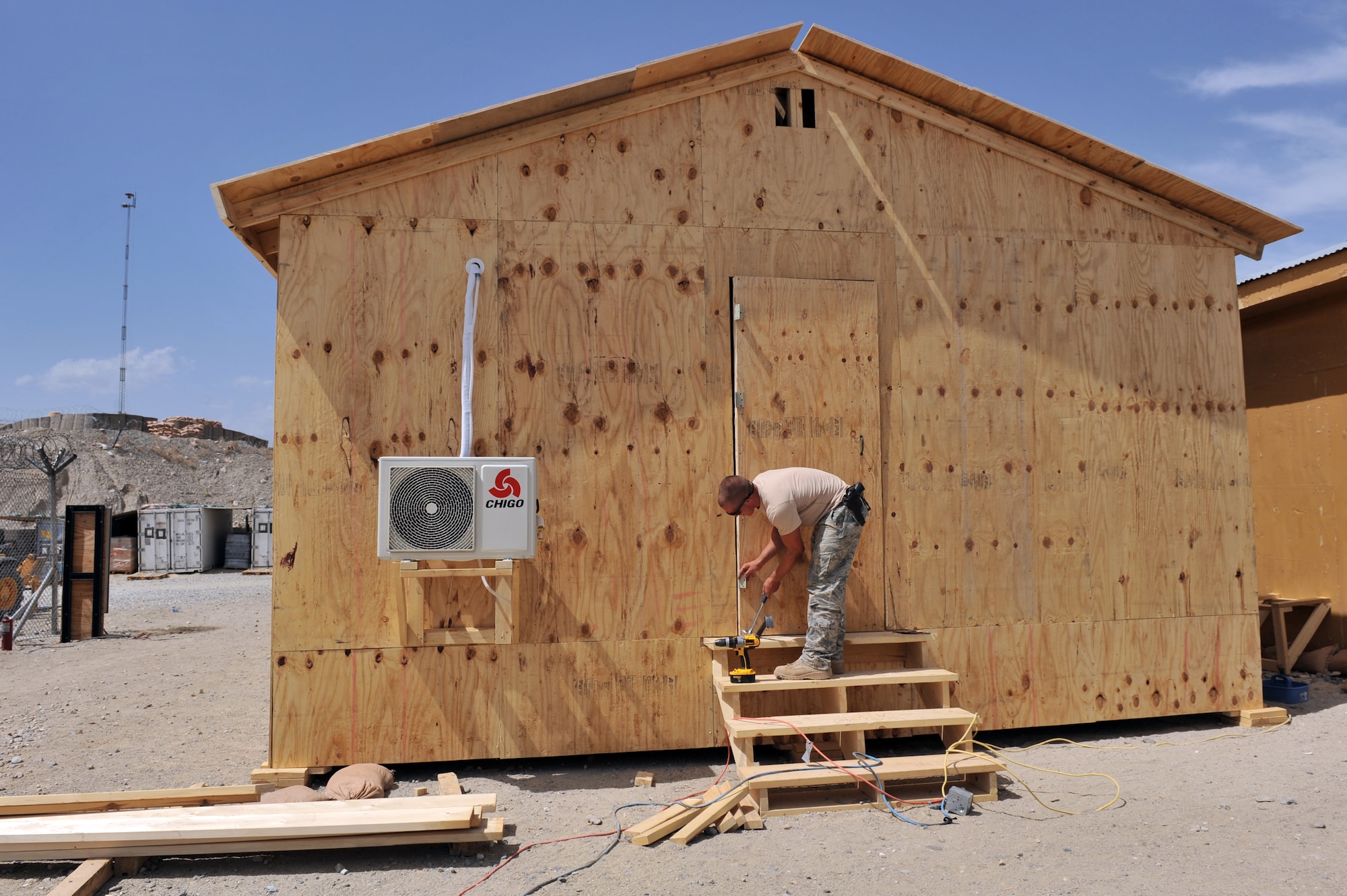 Airman 1st Class Tyler Saulsgiver, 577th Expeditionary Prime Base Engineer Emergency Force Squadron structural journeyman, installs a door on a newly built dining facility expansion at a combat outpost, Afghanistan, May 23, 2011. Airman Saulsgiver is deployed from Travis Air Force Base, Calif., and is a native of Panama, N.Y. (U.S. Air Force photo by Senior Airman Sheila deVera)