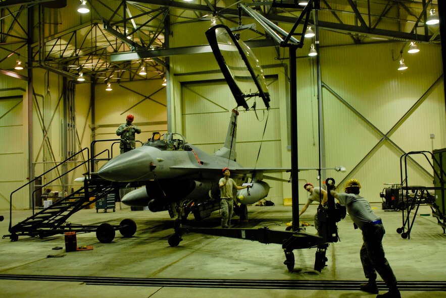 KWANGJU AIR BASE, Republic of Korea -- Airmen from both the 8th Fighter Wing at Kunsan AB and the 51st Fighter Wing at Osan AB, repair a damaged cockpit of an F-16 Fighting Falcon during Max Thunder 11-1 here May 25. The exercise gave peninsula Airmen an opportunity to sharpen their ability to work together in a simulated war-time environment. (U.S. Air Force photo/Senior Airman Benjamin Stratton)